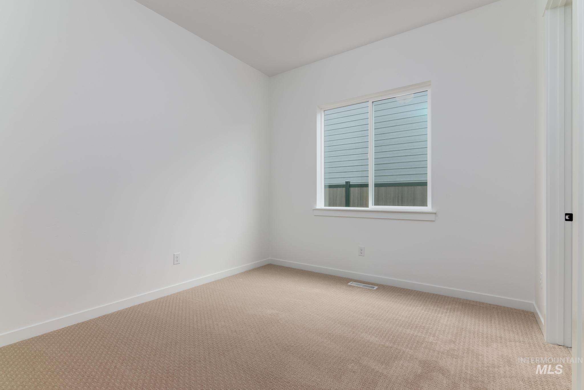 Unfurnished room featuring baseboards and carpet