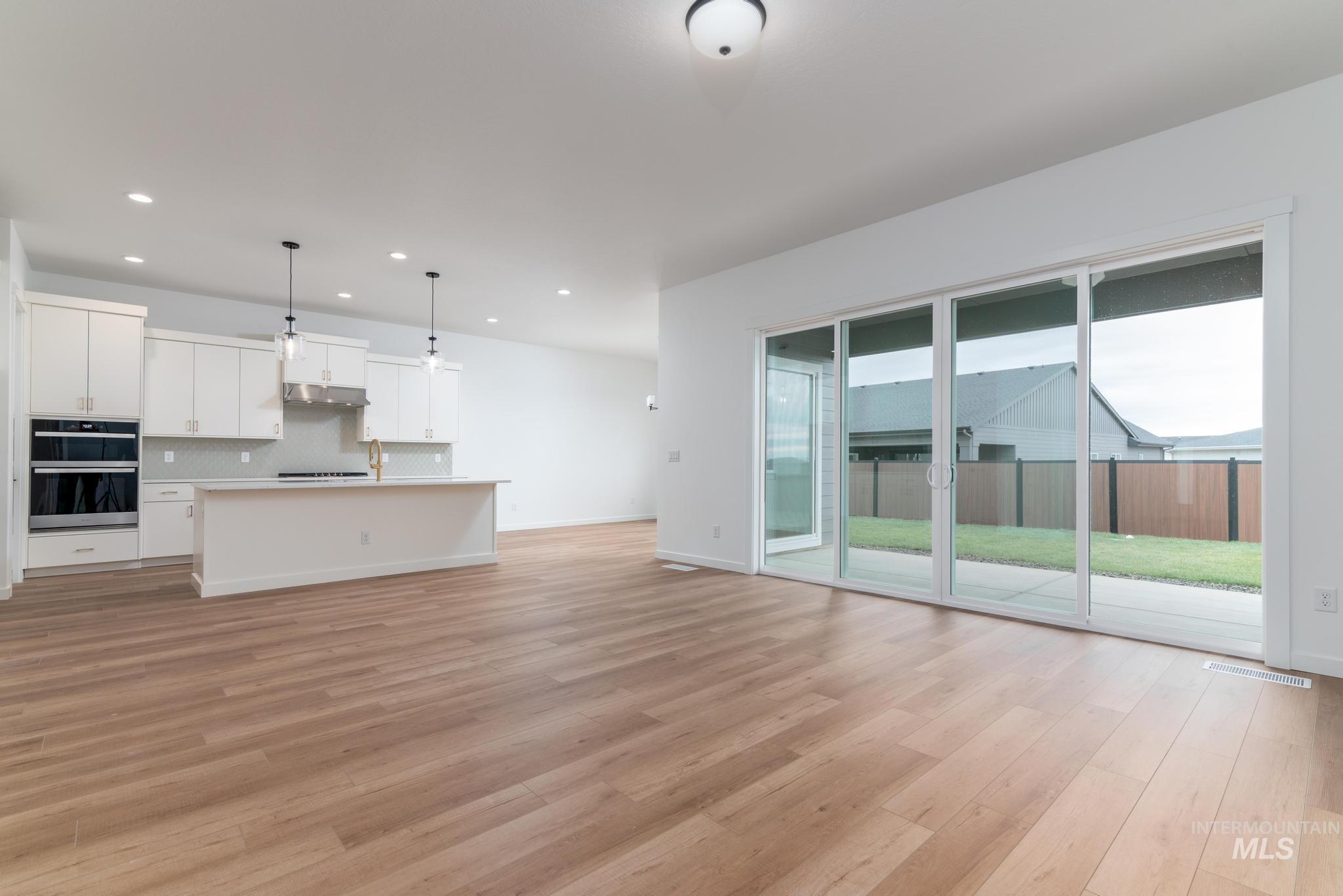 Unfurnished living room featuring light wood-style floors and recessed lighting