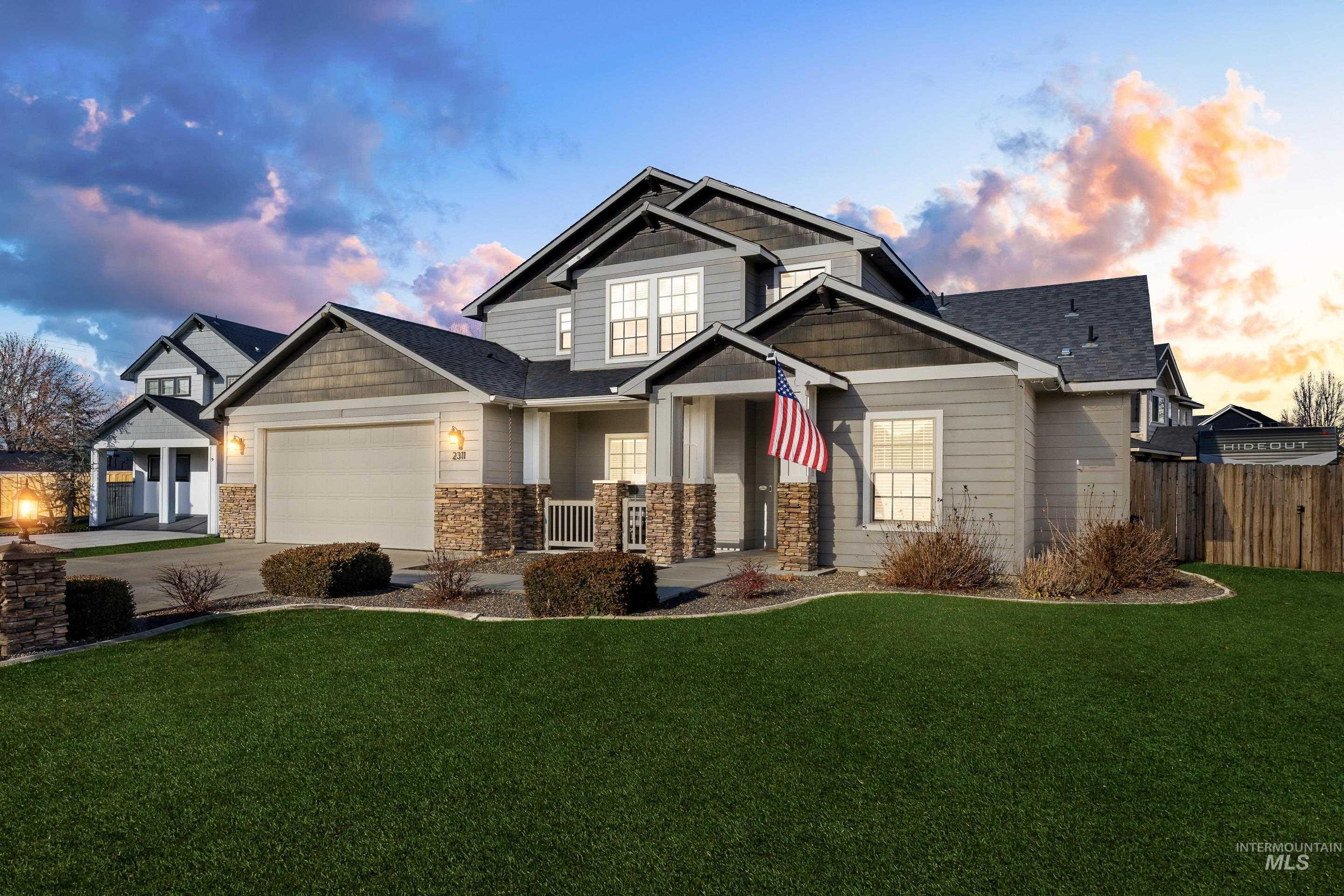 Craftsman-style home with driveway, a garage, stone siding, and covered porch
