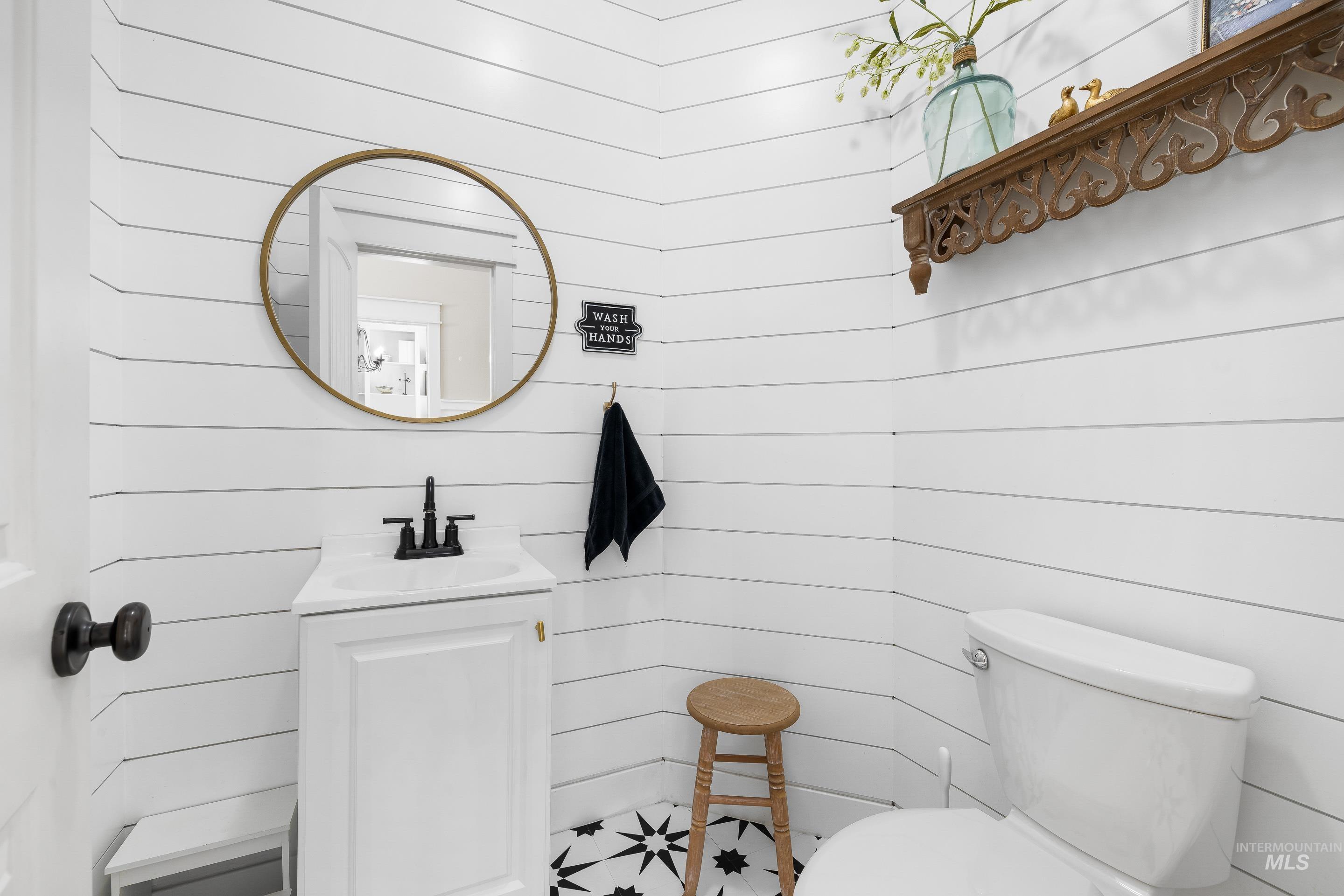 Bathroom featuring vanity and wood walls