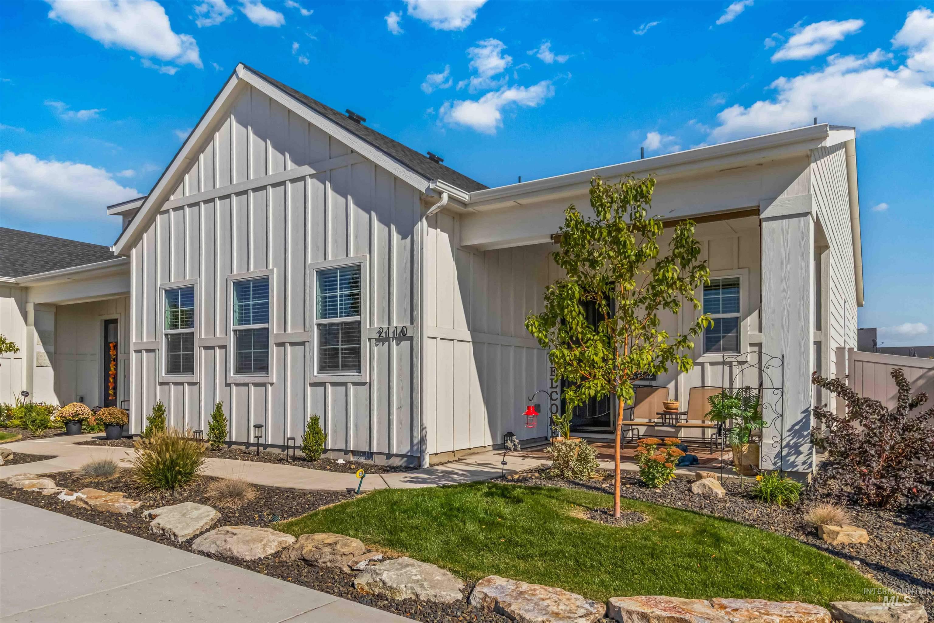 View of front of house featuring board and batten siding and a front yard