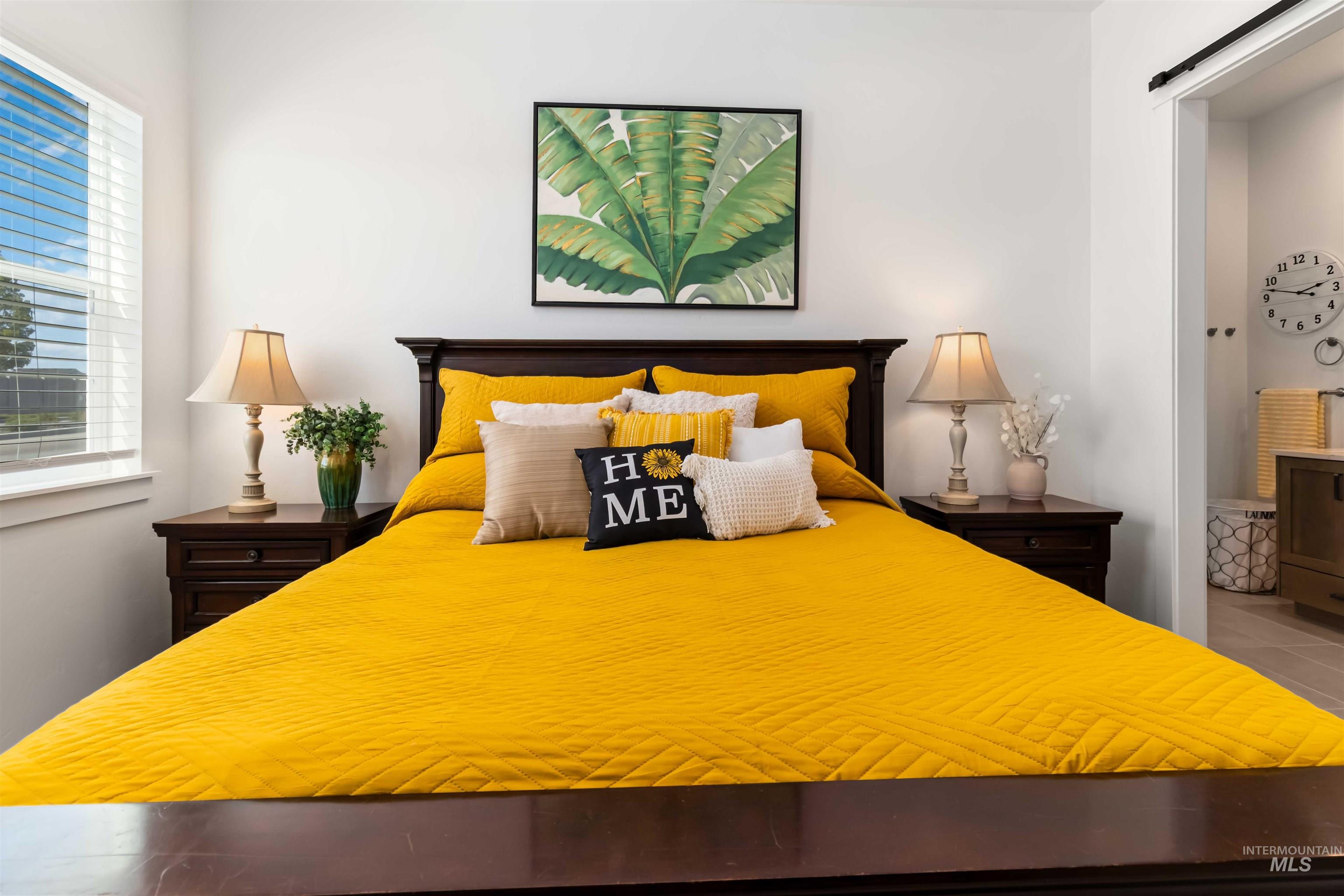 Primary Bedroom featuring a barn door