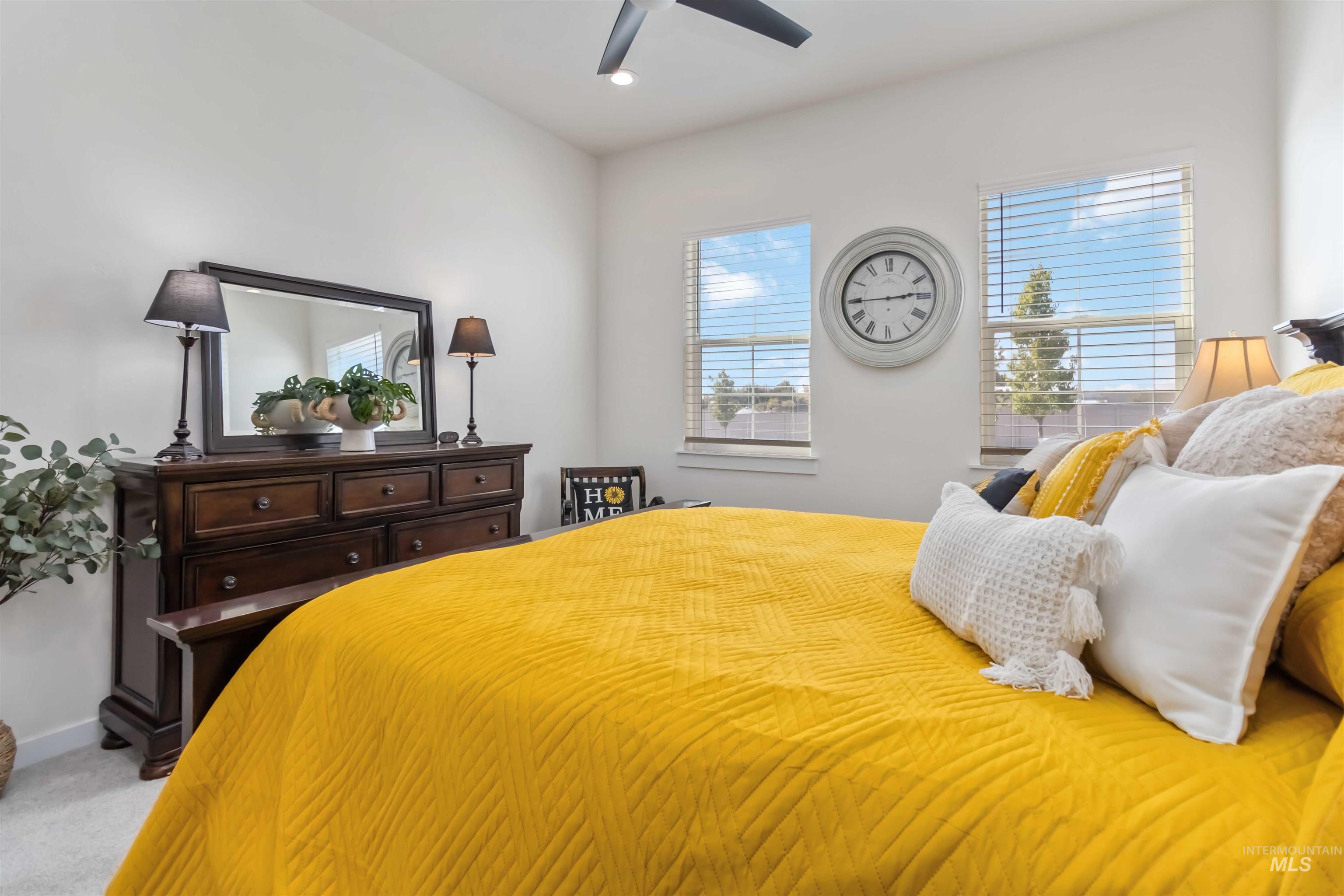 Bedroom with light colored carpet, recessed lighting, and a ceiling fan