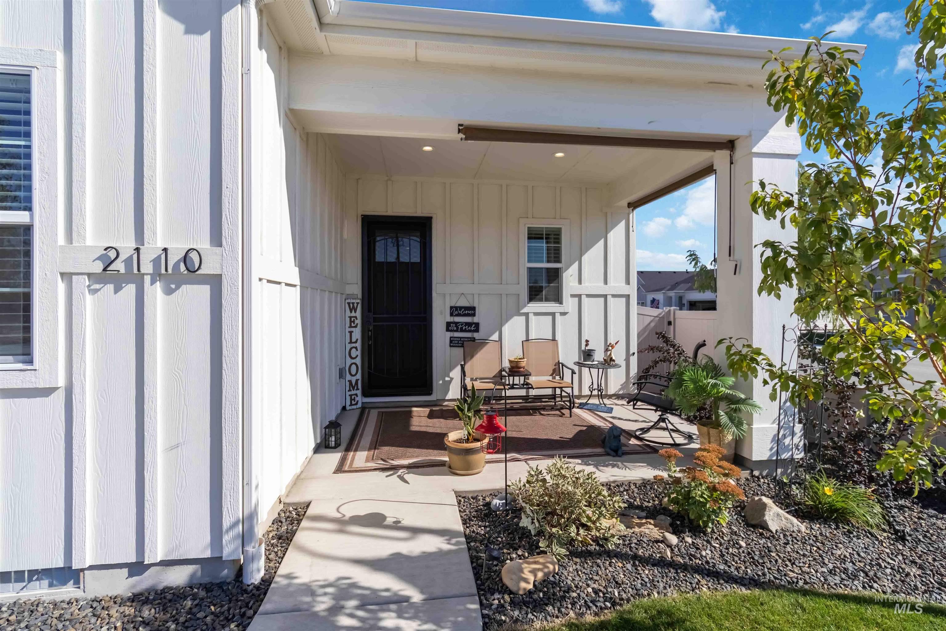 Doorway to property with a porch and board and batten siding