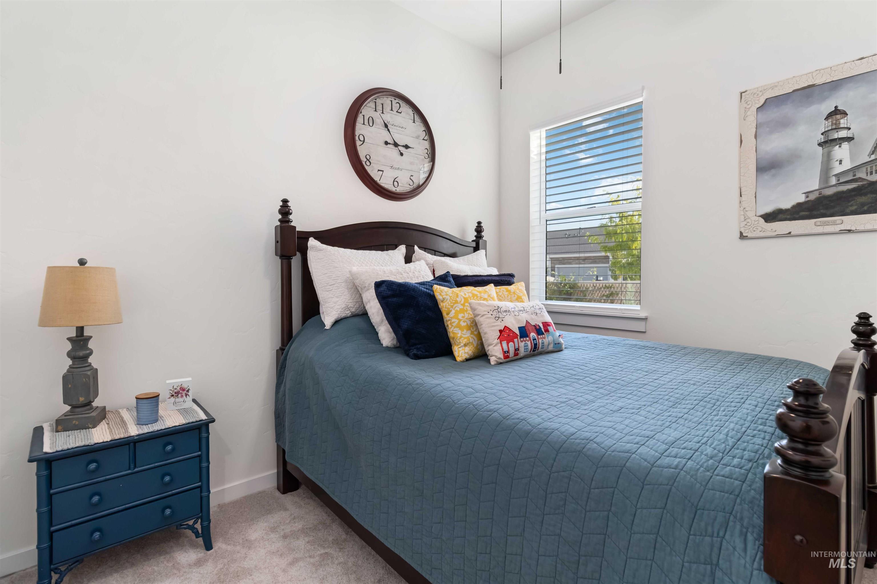 Bedroom featuring light colored carpet and baseboards