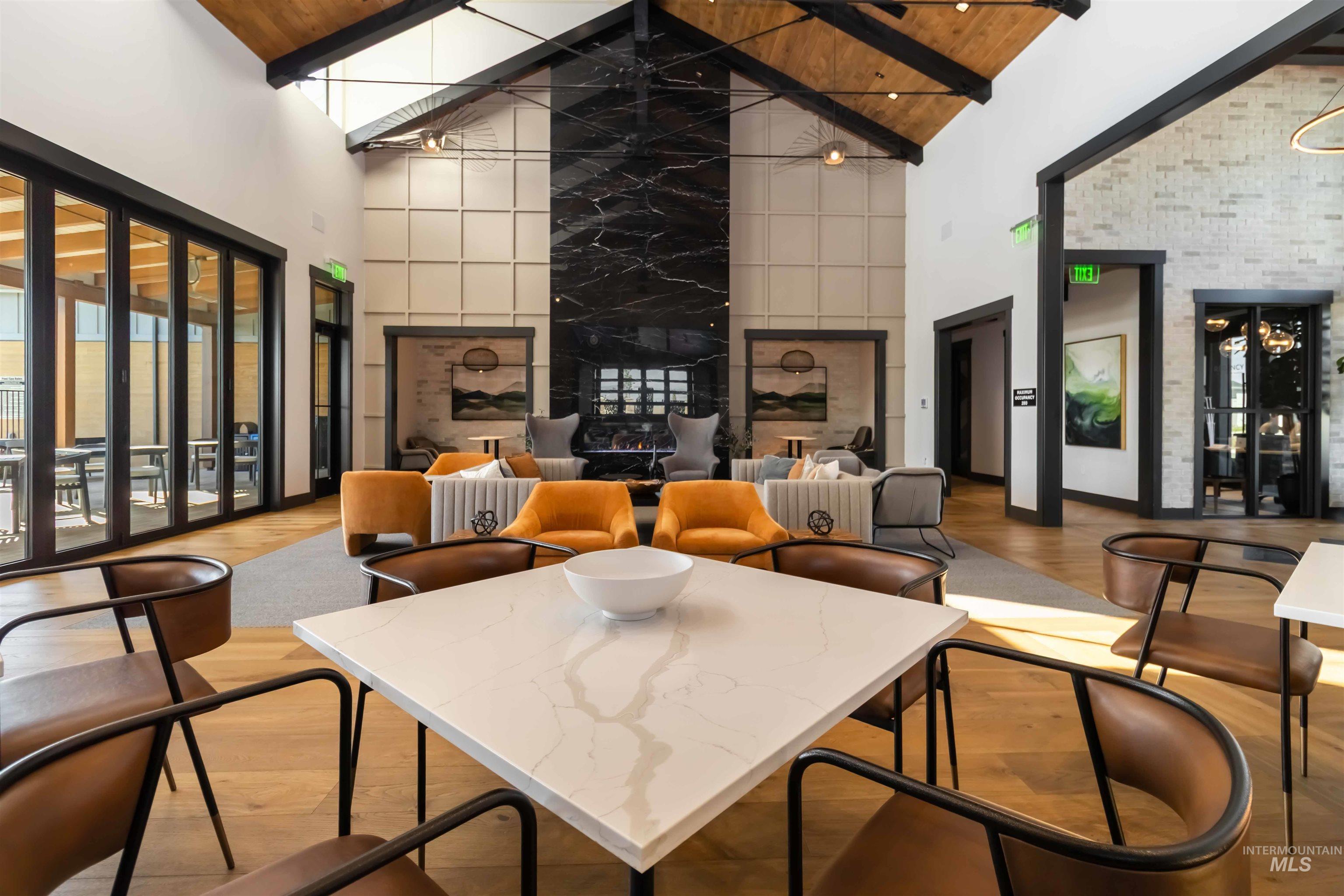 Club House gathering area with high vaulted ceiling and  impressive windows wooded ceiling with exposed beams. Abundance of gathering areas.