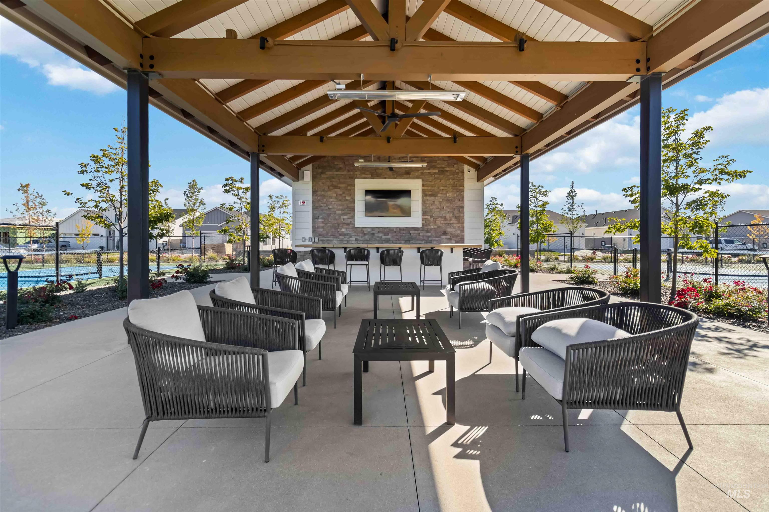View of patio / terrace with an outdoor hangout area, a residential view, large TV's and ceiling fans for added comfort