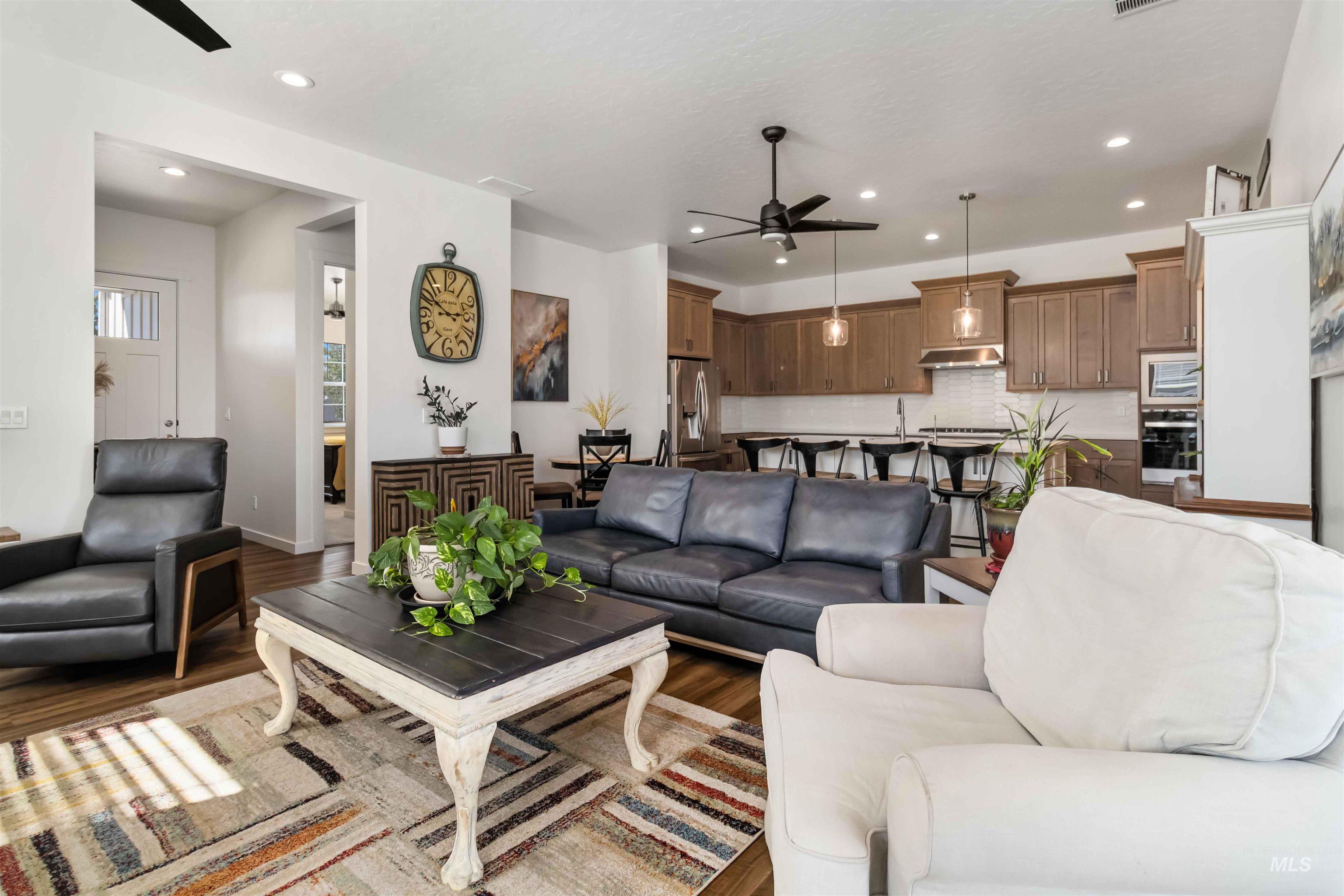 Living area featuring ceiling fan, wood finished floors, and recessed lighting