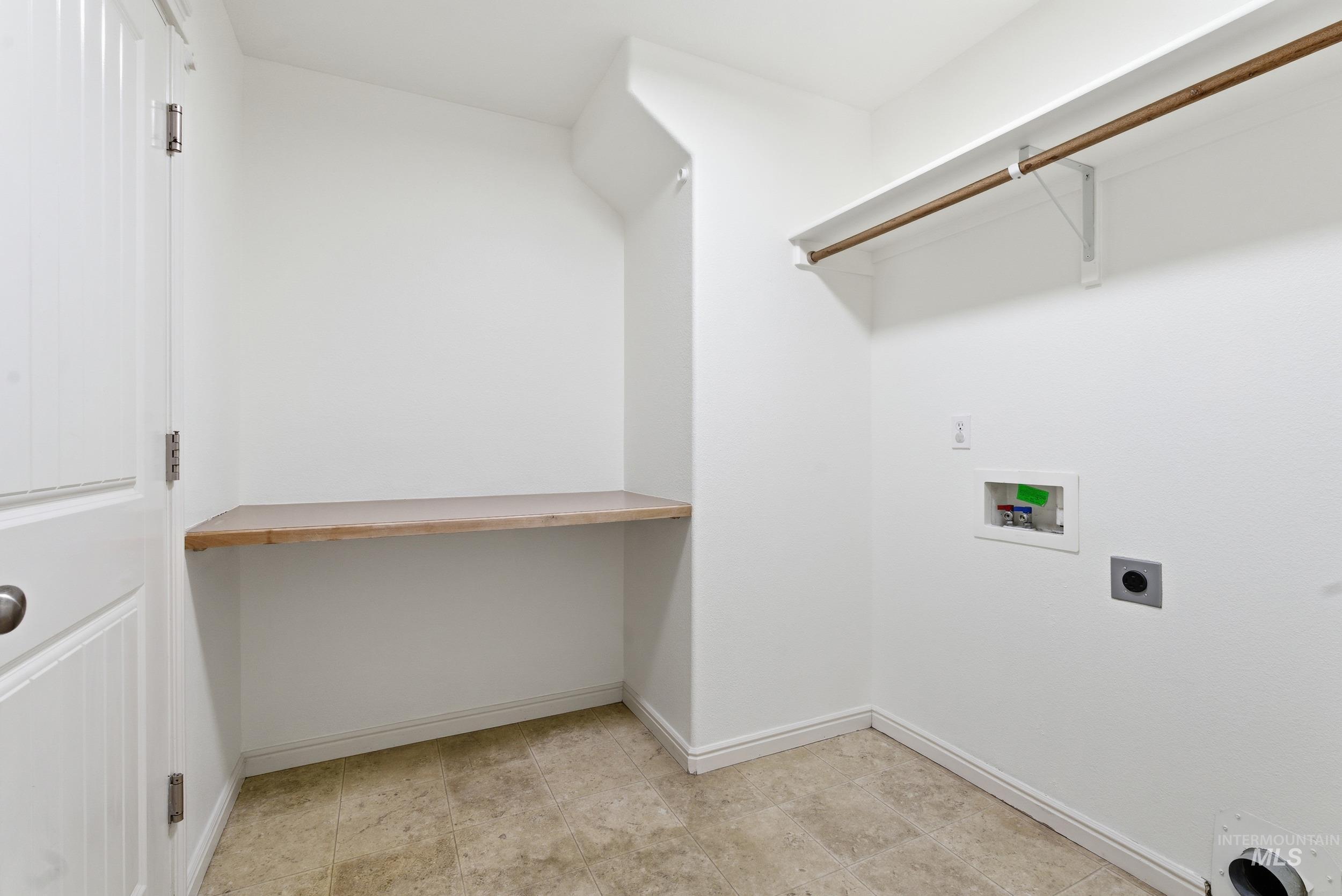 Washroom featuring hookup for a washing machine and hookup for an electric dryer