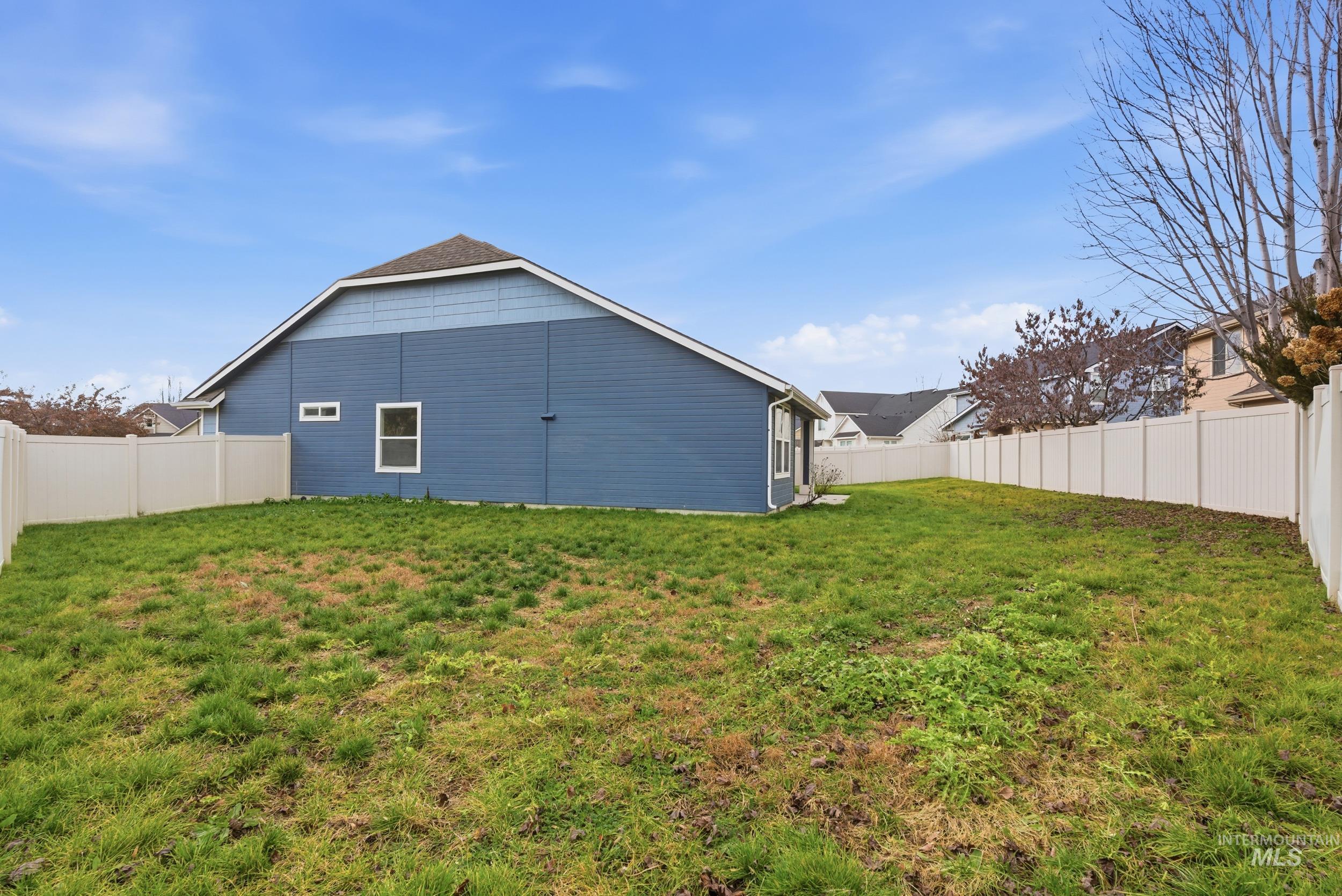 Rear view of property featuring a fenced backyard