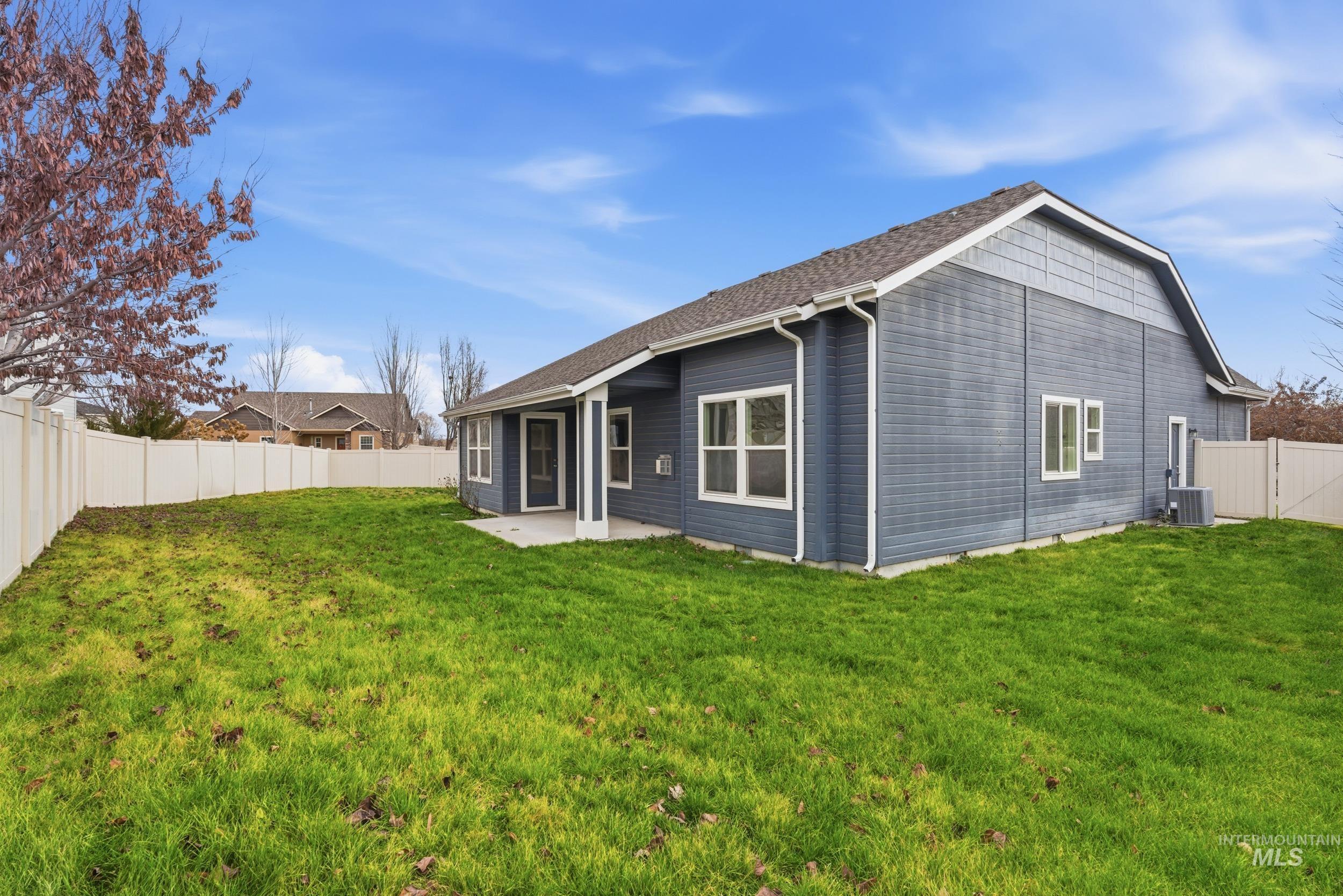 Back of house featuring a fenced backyard and a patio