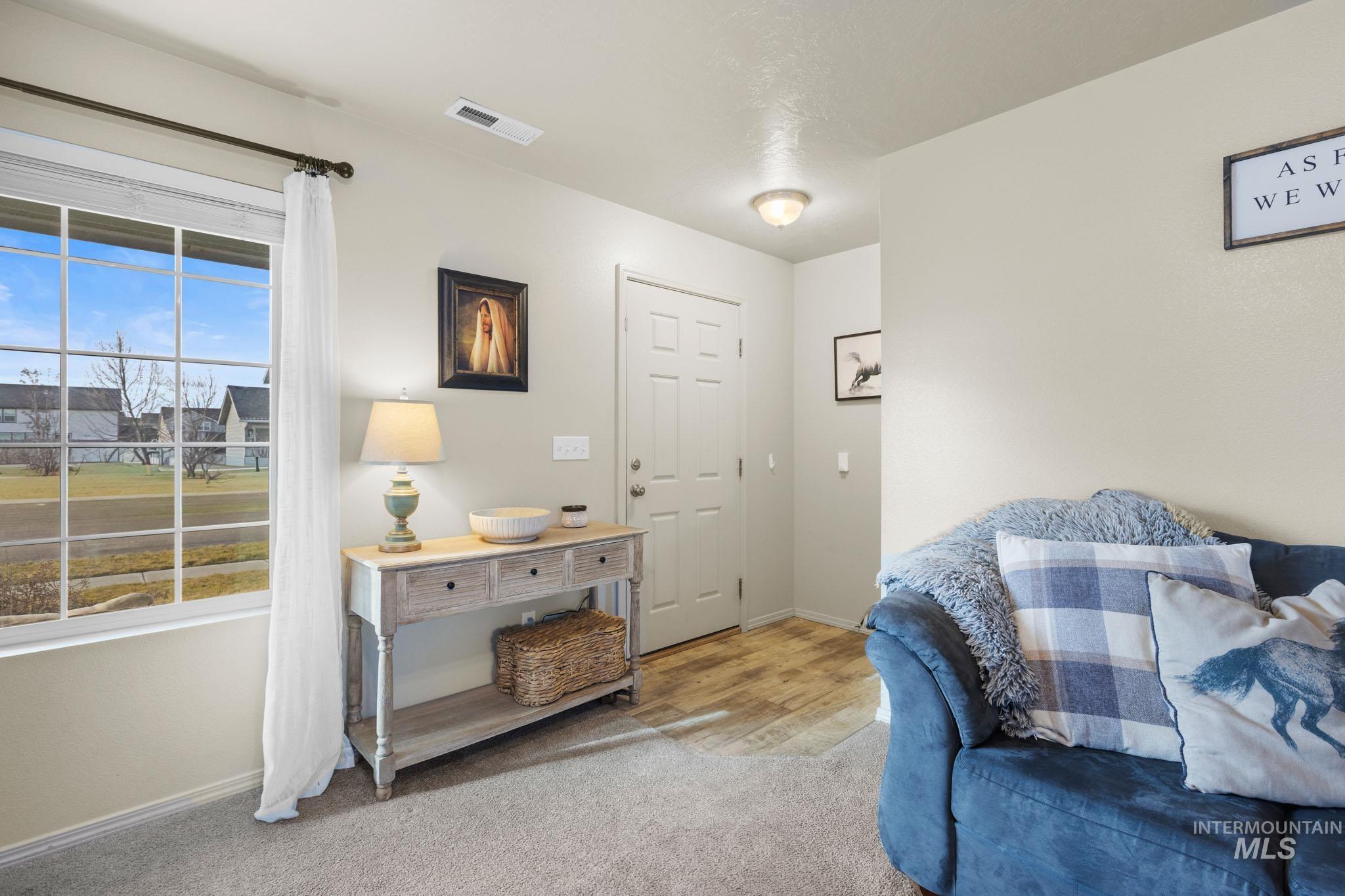 Living area featuring baseboards and carpet floors