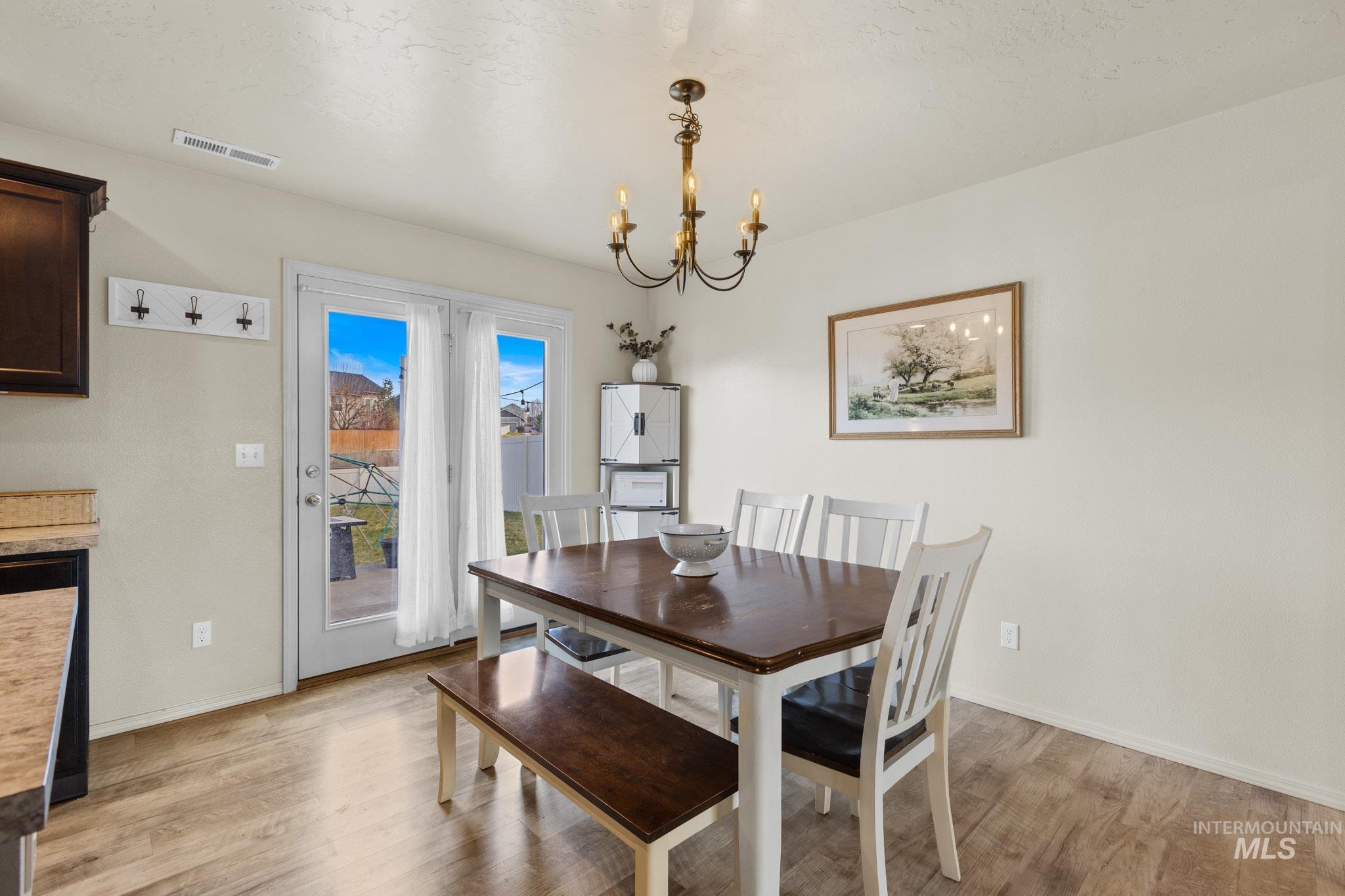 Dining room with a chandelier and light wood finished floors