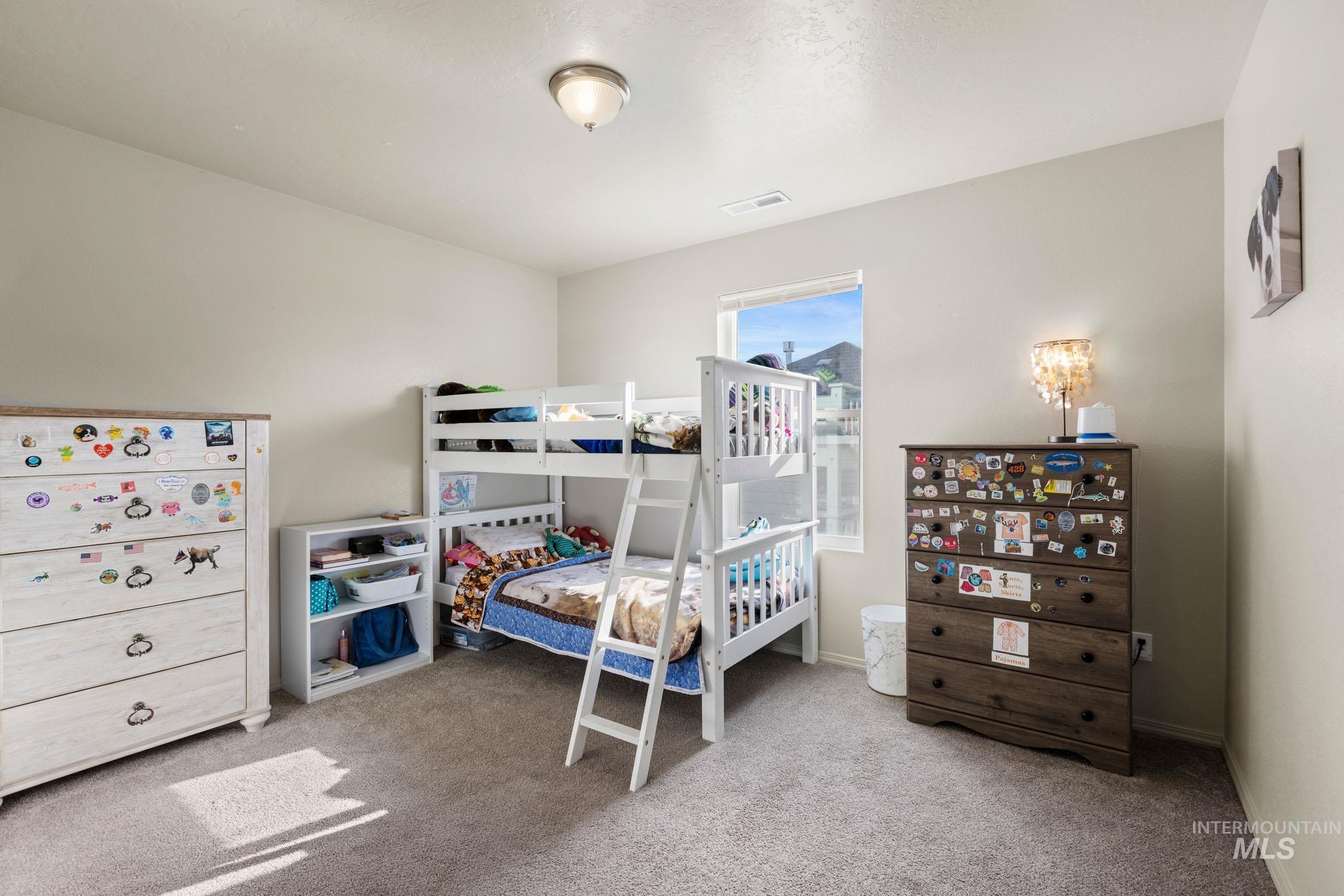 Bedroom with light colored carpet