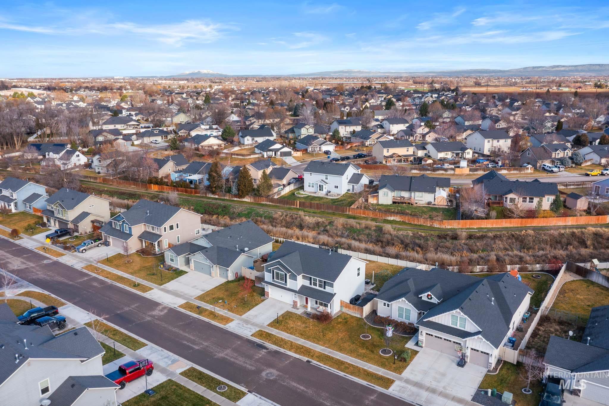 Aerial perspective of suburban area featuring a mountain backdrop