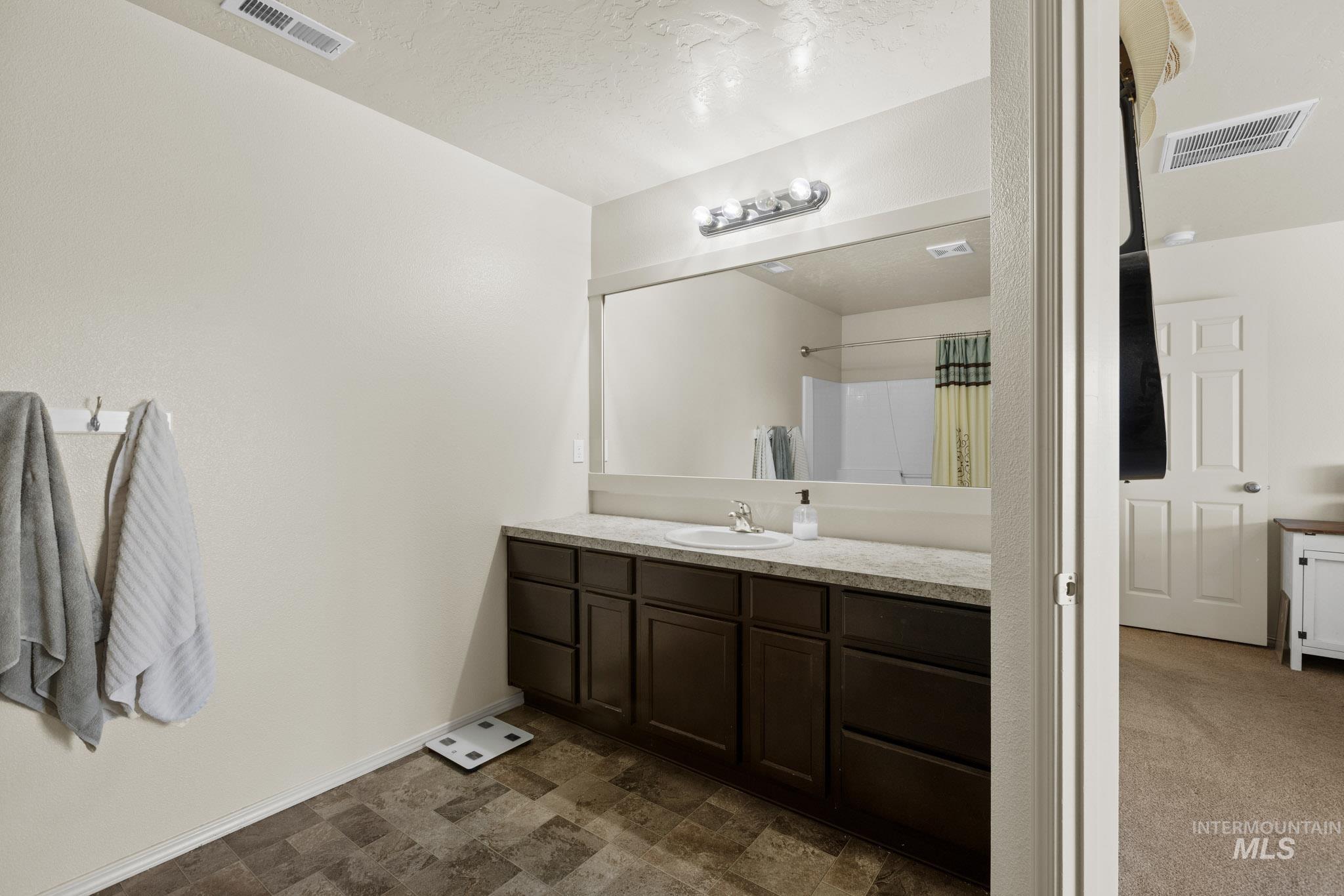 Bathroom featuring vanity and a shower with curtain
