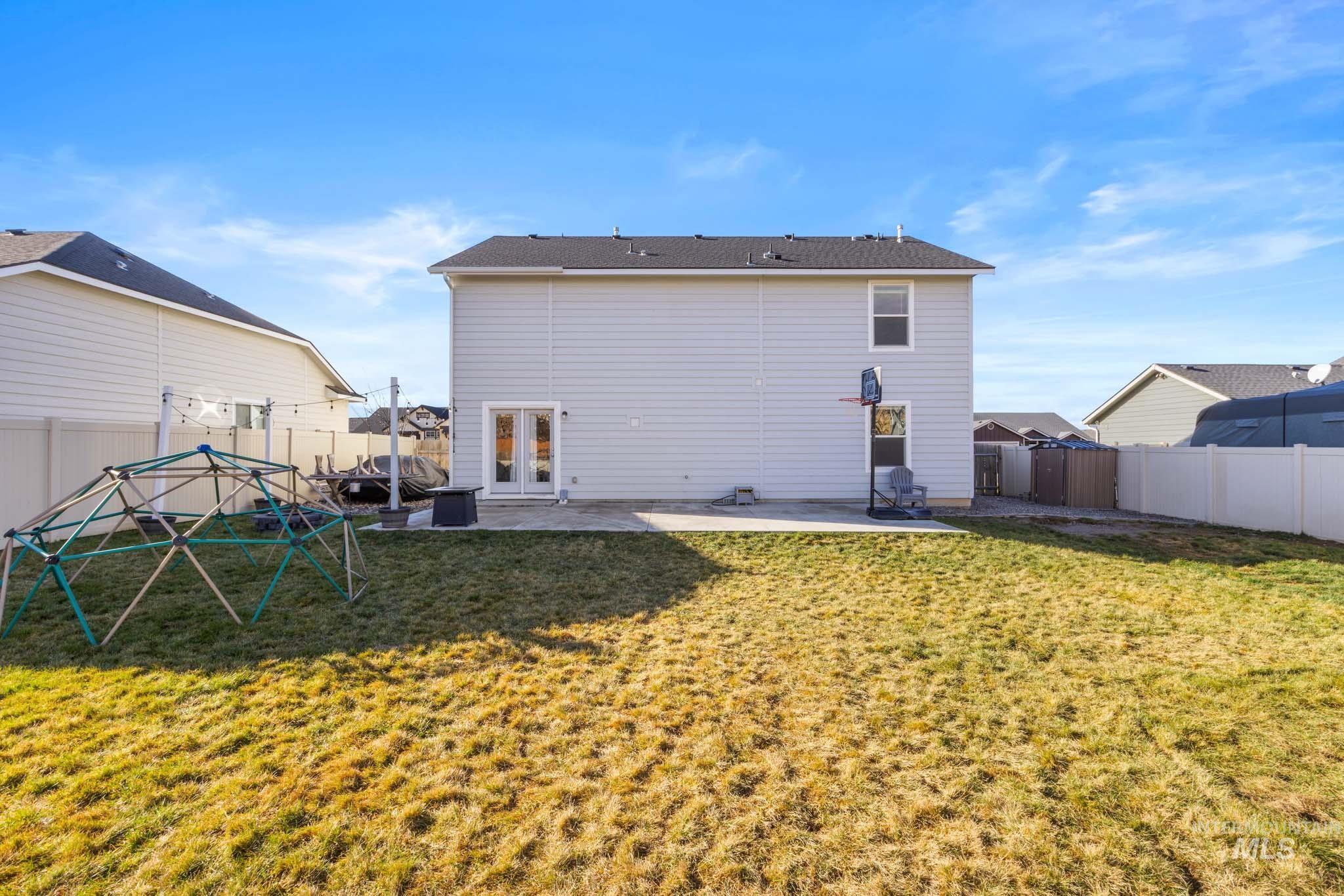 Back of property featuring a patio and a fenced backyard