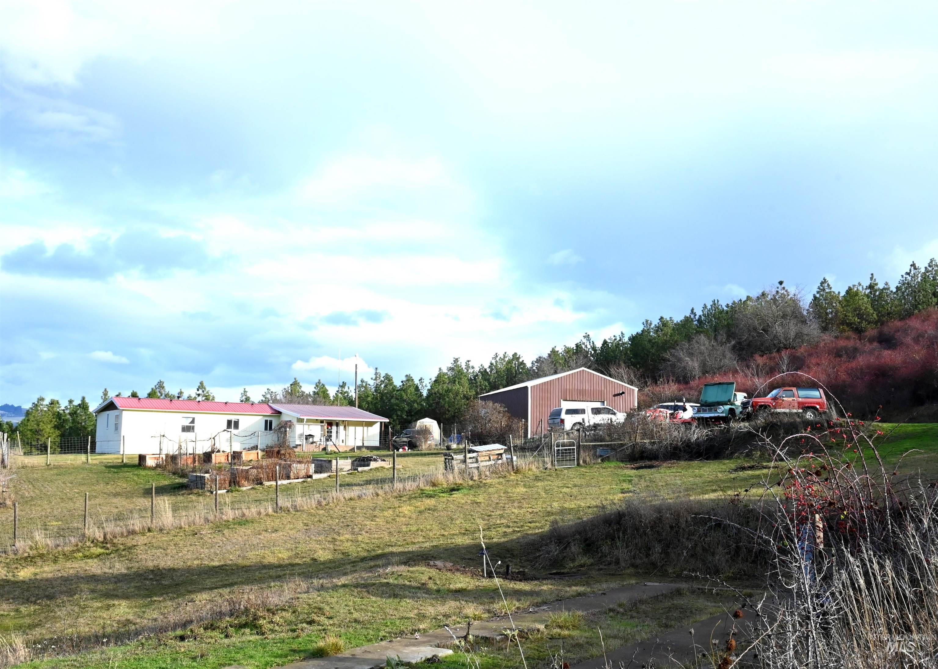 View of yard featuring a detached garage and a view of rural / pastoral area