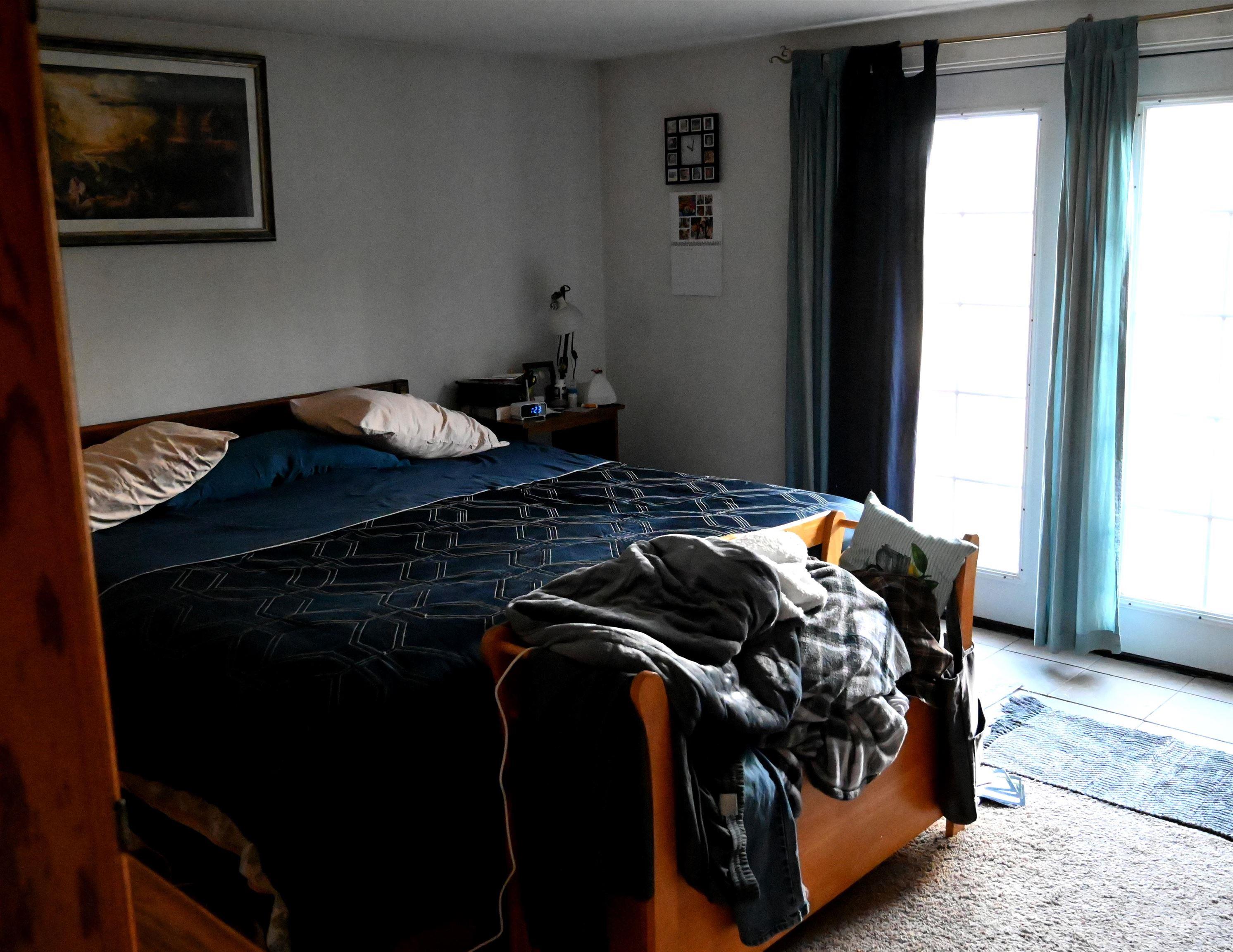 Tiled bedroom featuring carpet