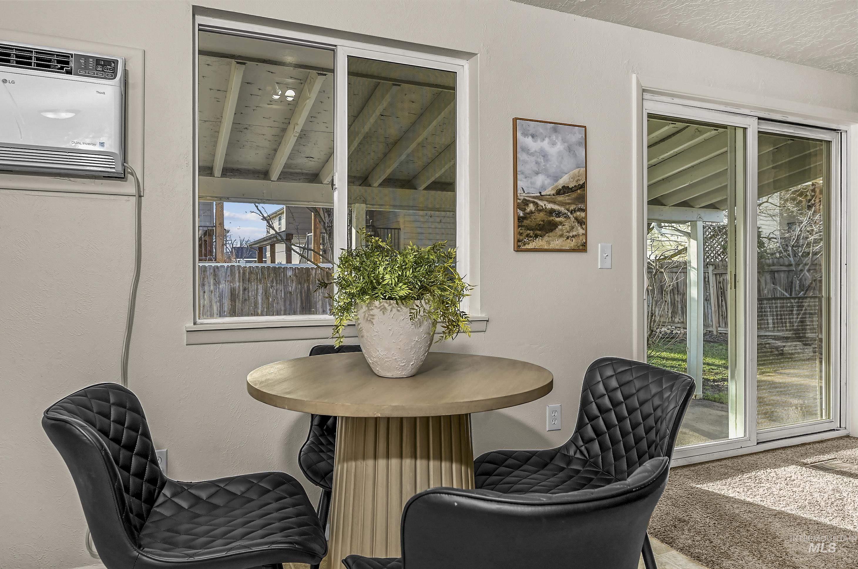 Carpeted dining room featuring healthy amount of natural light and a wall unit AC