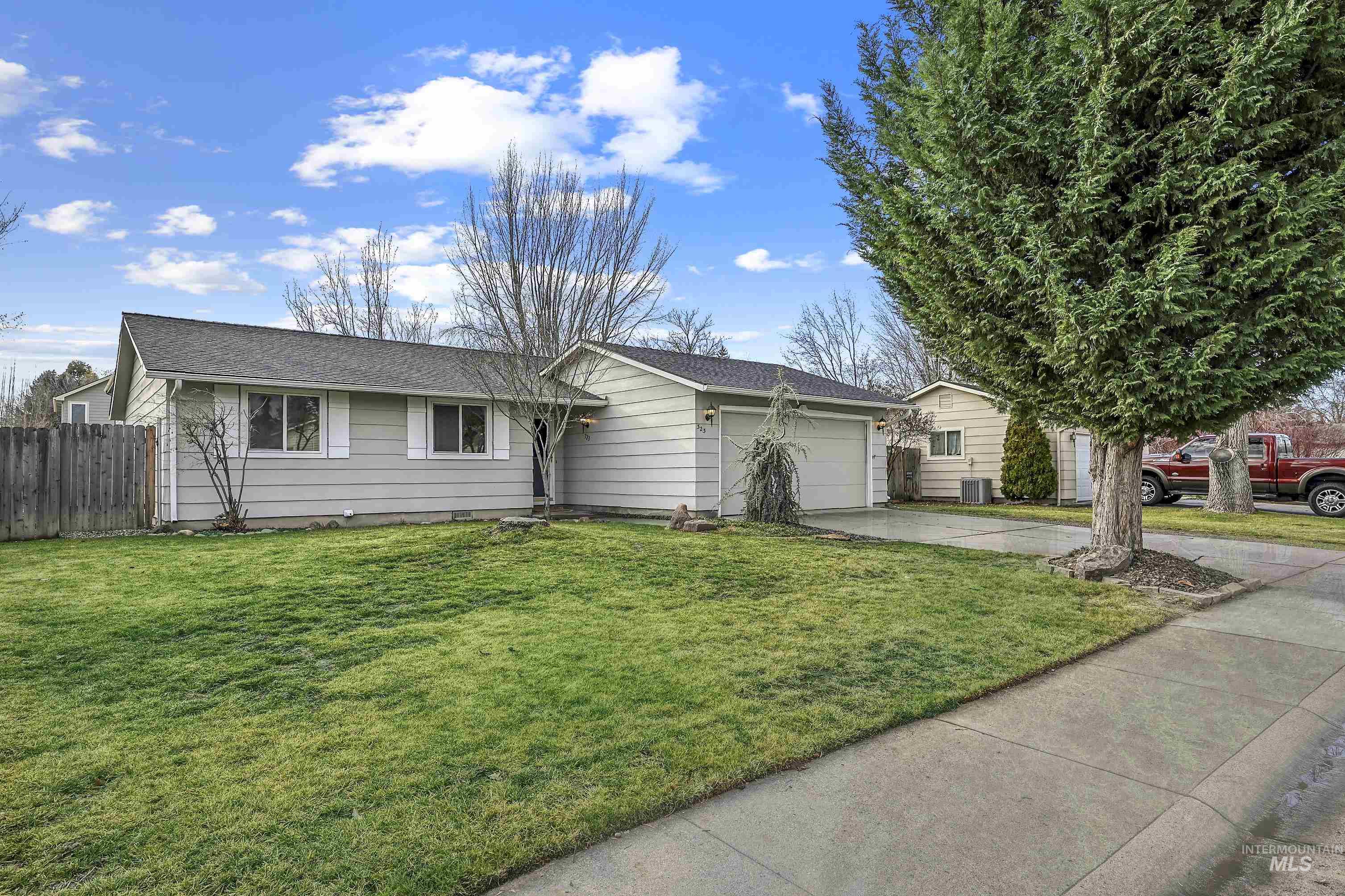 Ranch-style home with concrete driveway and an attached garage
