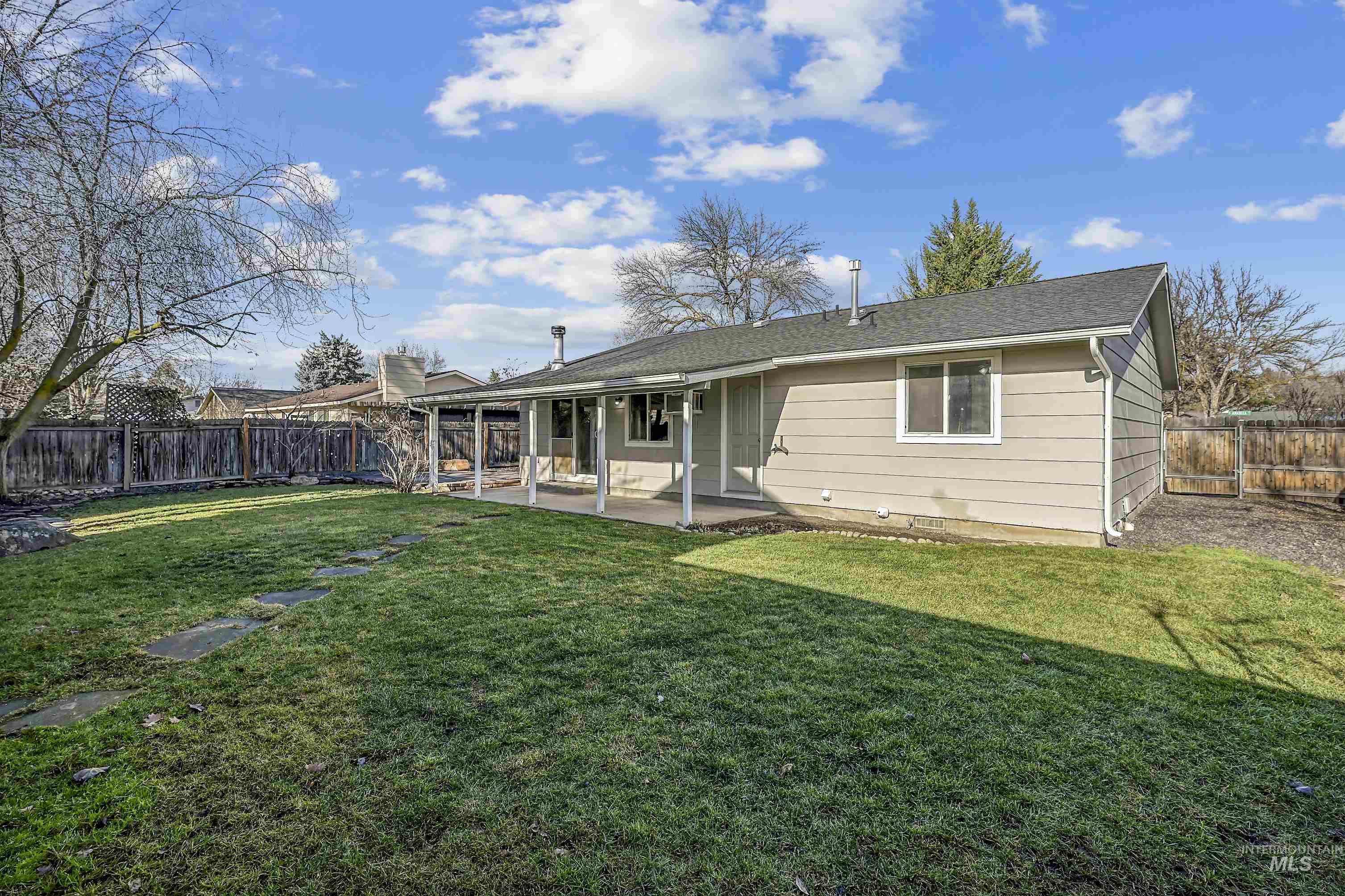 Rear view of property with a patio, a fenced backyard, and roof with shingles