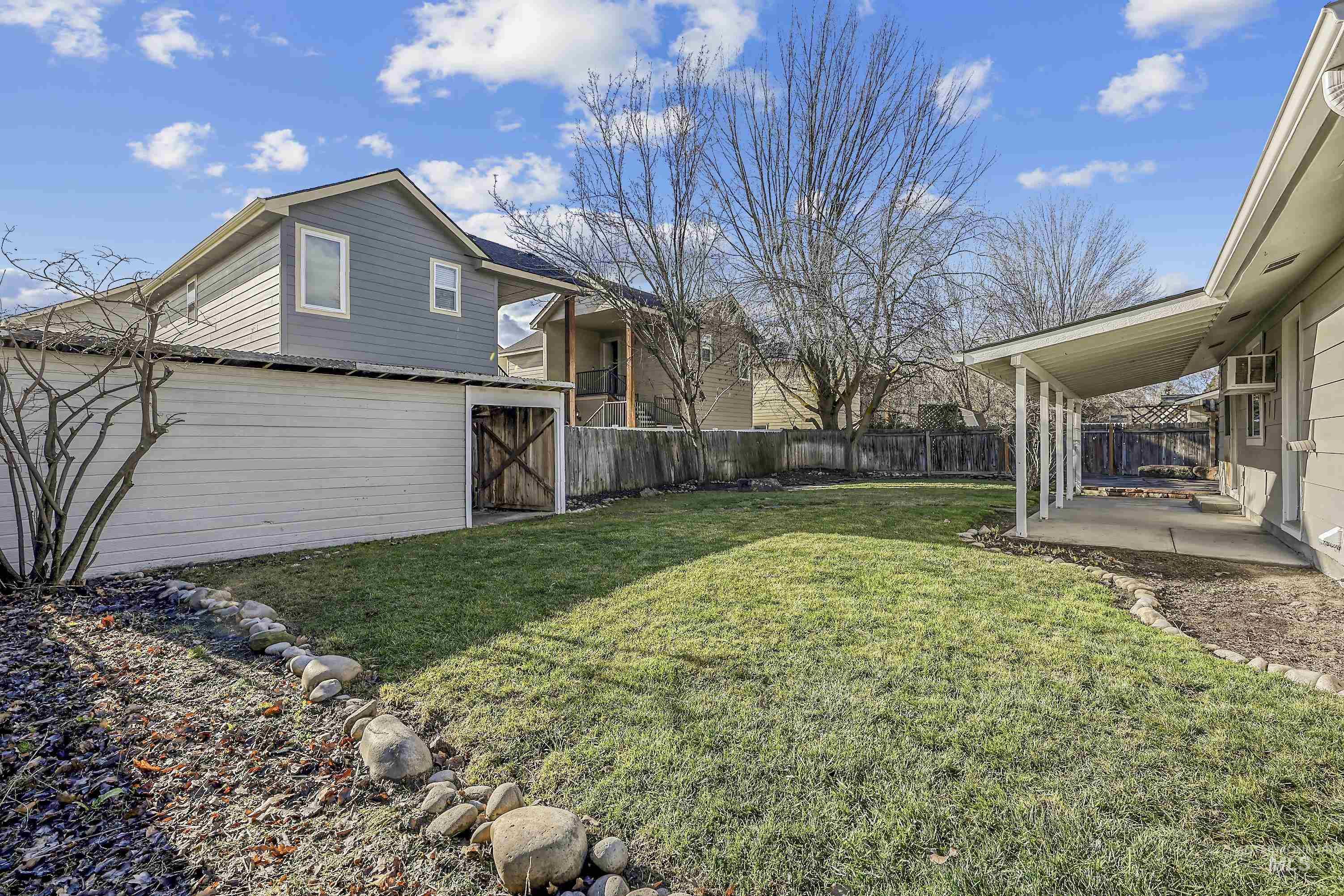 Fenced backyard featuring a patio