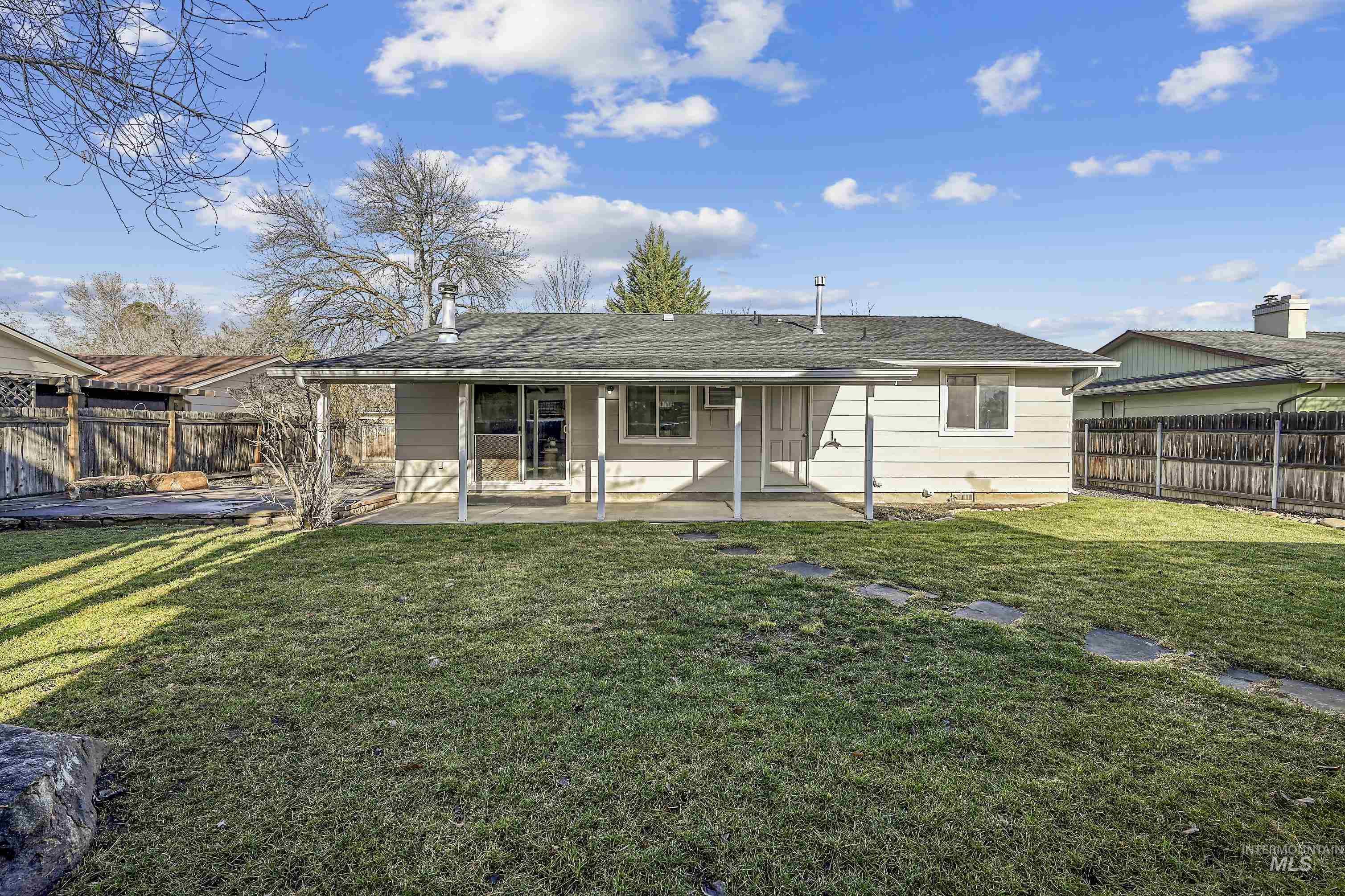 Rear view of property featuring a patio area and a fenced backyard