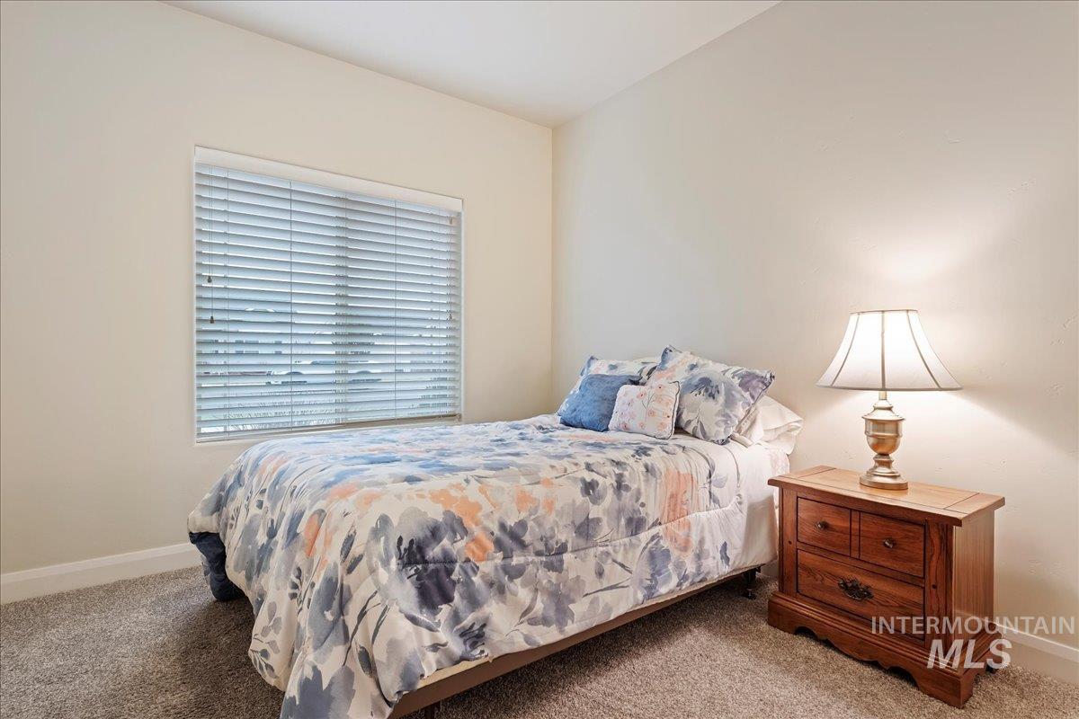 Carpeted bedroom featuring baseboards
