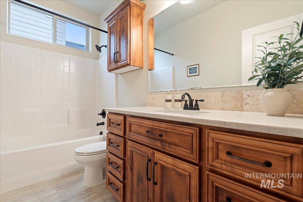 Bathroom with vanity and bathing tub / shower combination