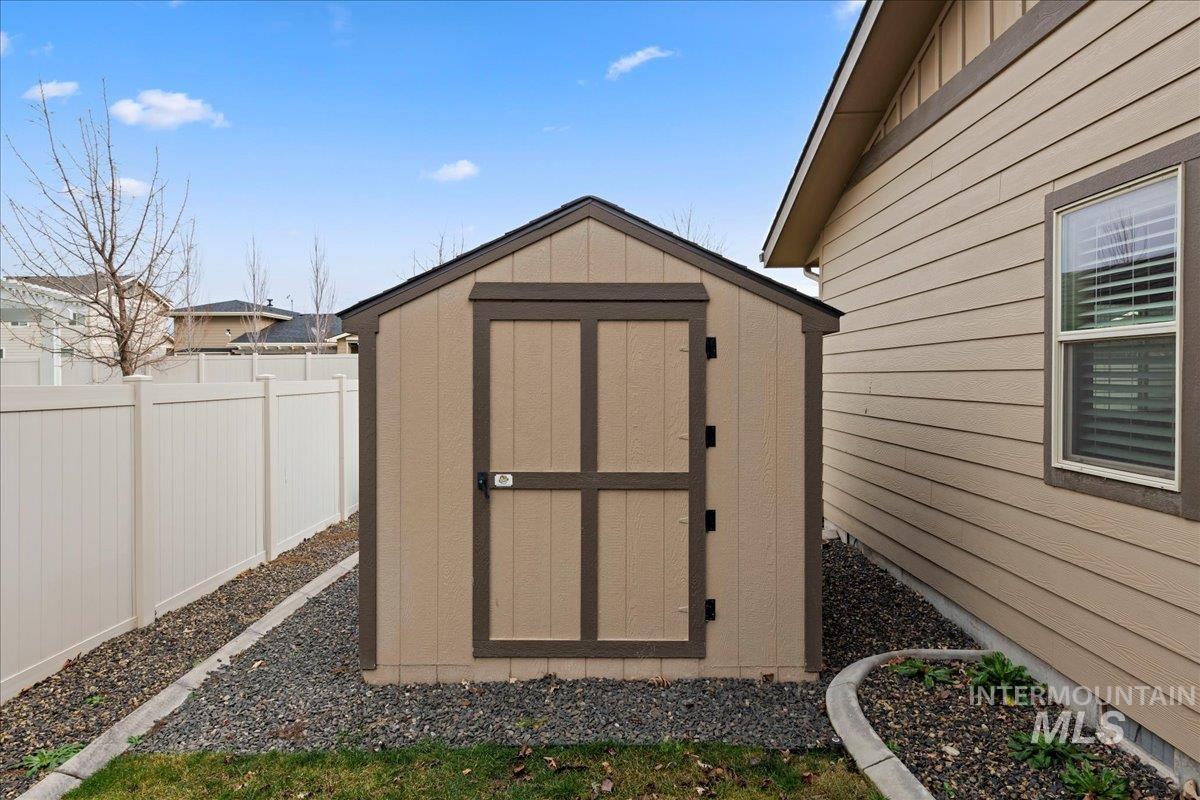 View of shed featuring a fenced backyard