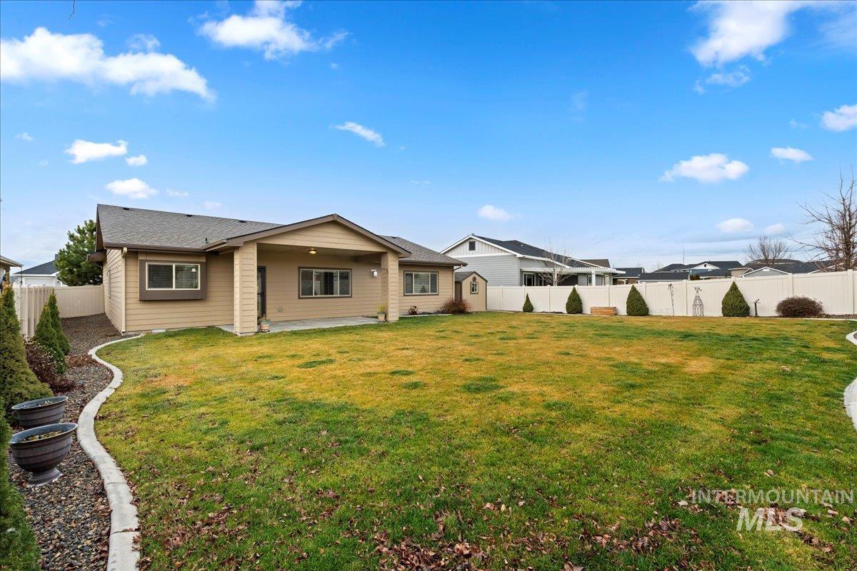 Back of property featuring a patio area and a fenced backyard