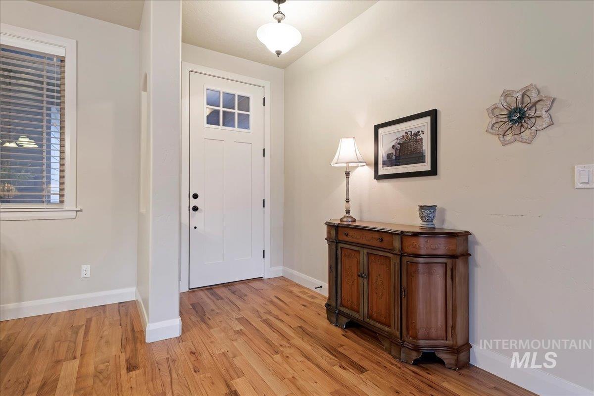 Foyer entrance featuring light wood finished floors and baseboards