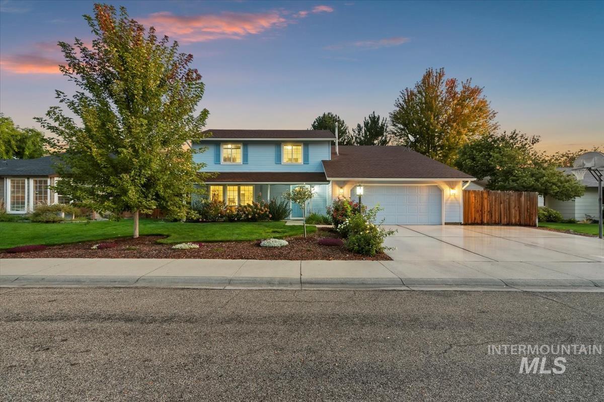 Traditional-style house featuring concrete driveway and a garage