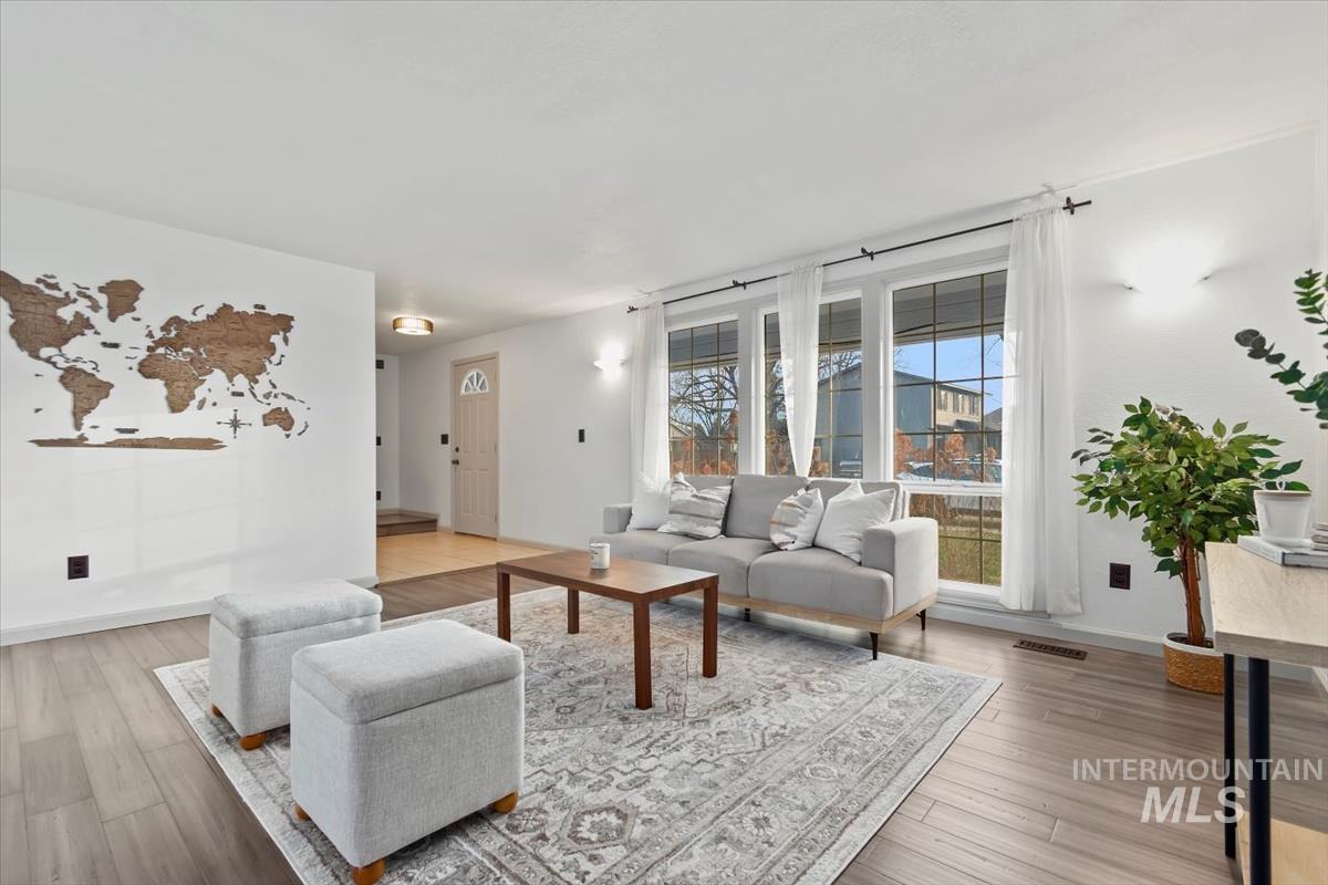 Living room with light wood-type flooring and baseboards