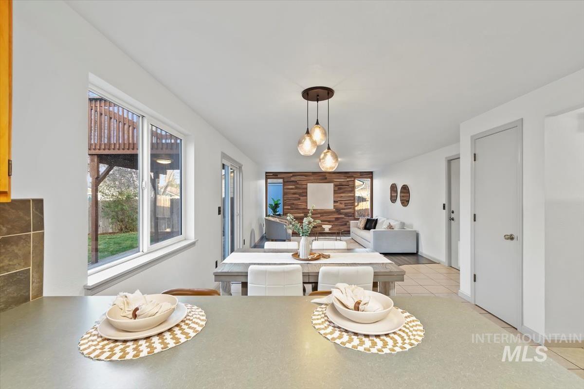Dining space featuring light tile patterned flooring and baseboards