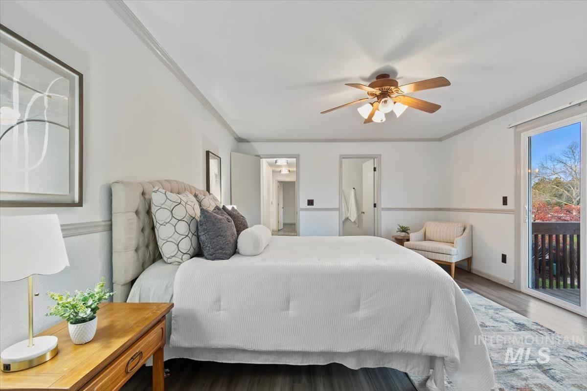 Bedroom featuring access to exterior, crown molding, wood finished floors, and a ceiling fan