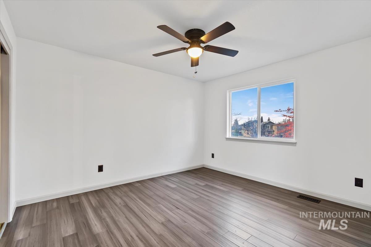 Spare room featuring light wood-type flooring and ceiling fan