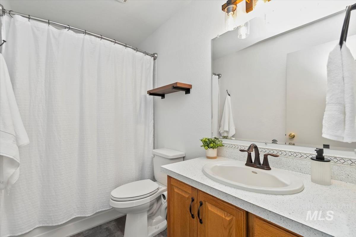 Full bathroom with vanity and shower / bathtub combination with curtain