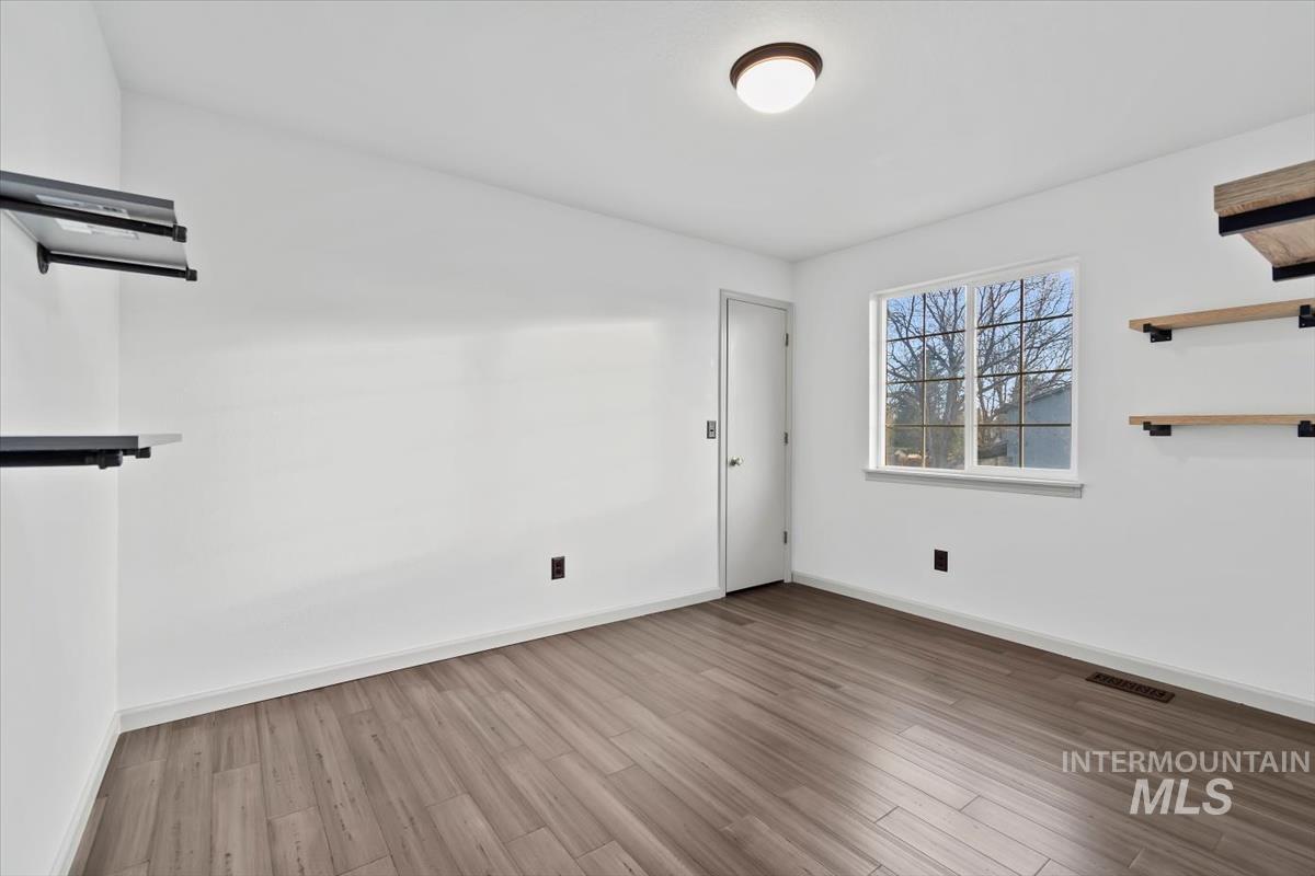 Spare room with wood finished floors and baseboards