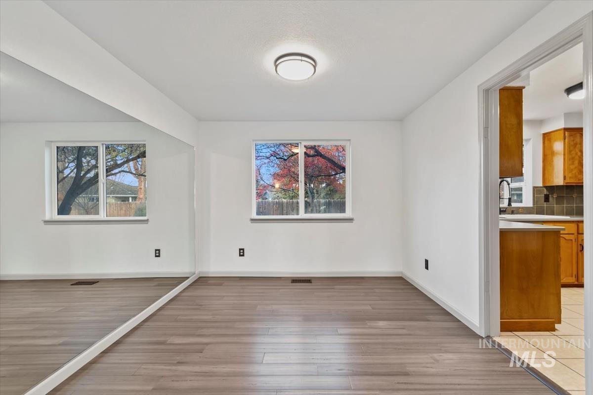 Unfurnished dining area with light wood-type flooring and plenty of natural light