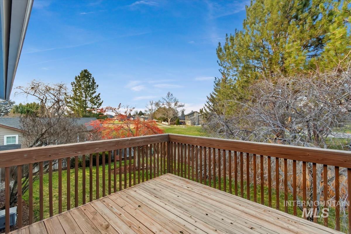 Wooden deck with a residential view and a yard