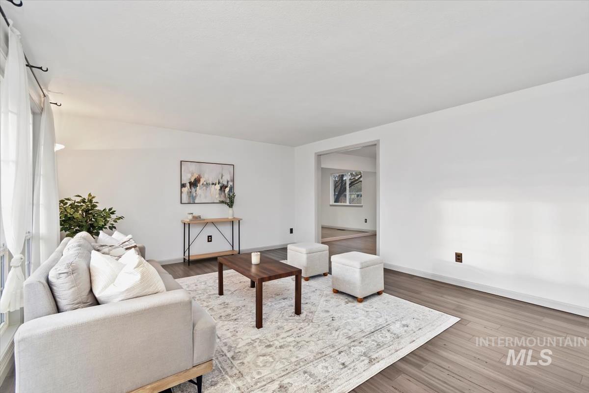 Living room with wood finished floors and healthy amount of natural light