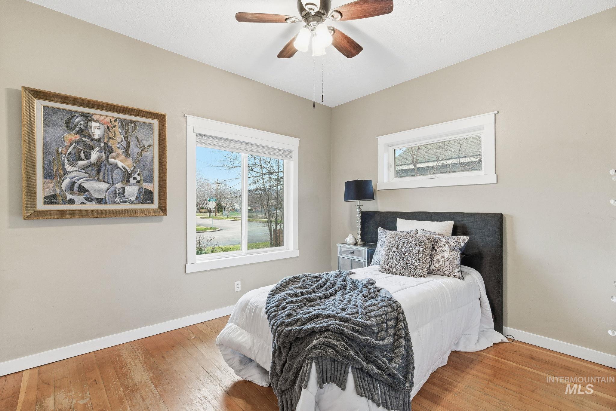 Bedroom featuring hardwood / wood-style floors and a ceiling fan