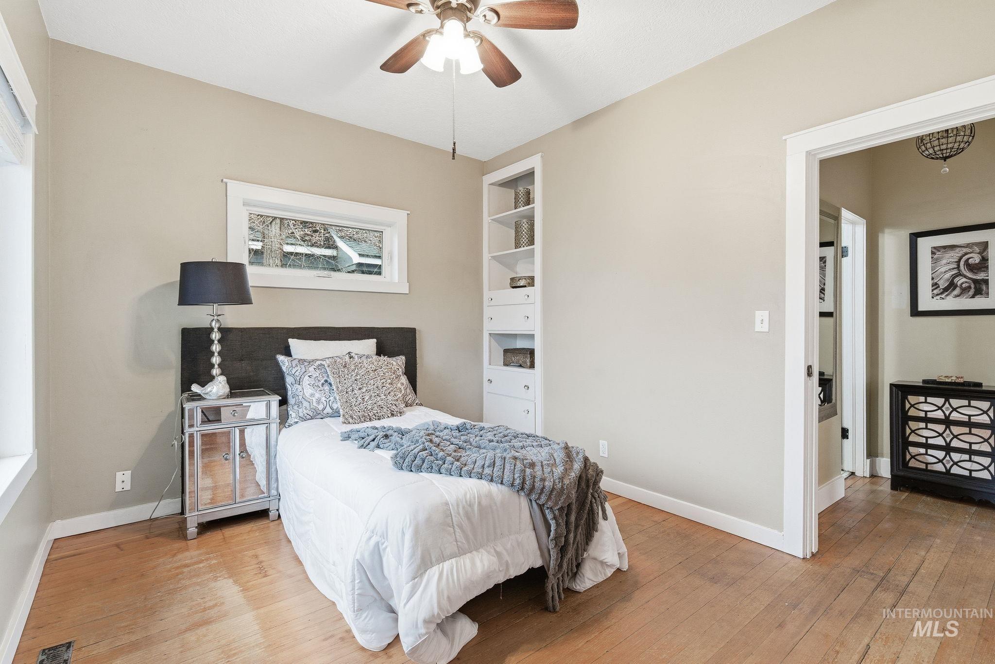 Bedroom featuring wood-type flooring and ceiling fan