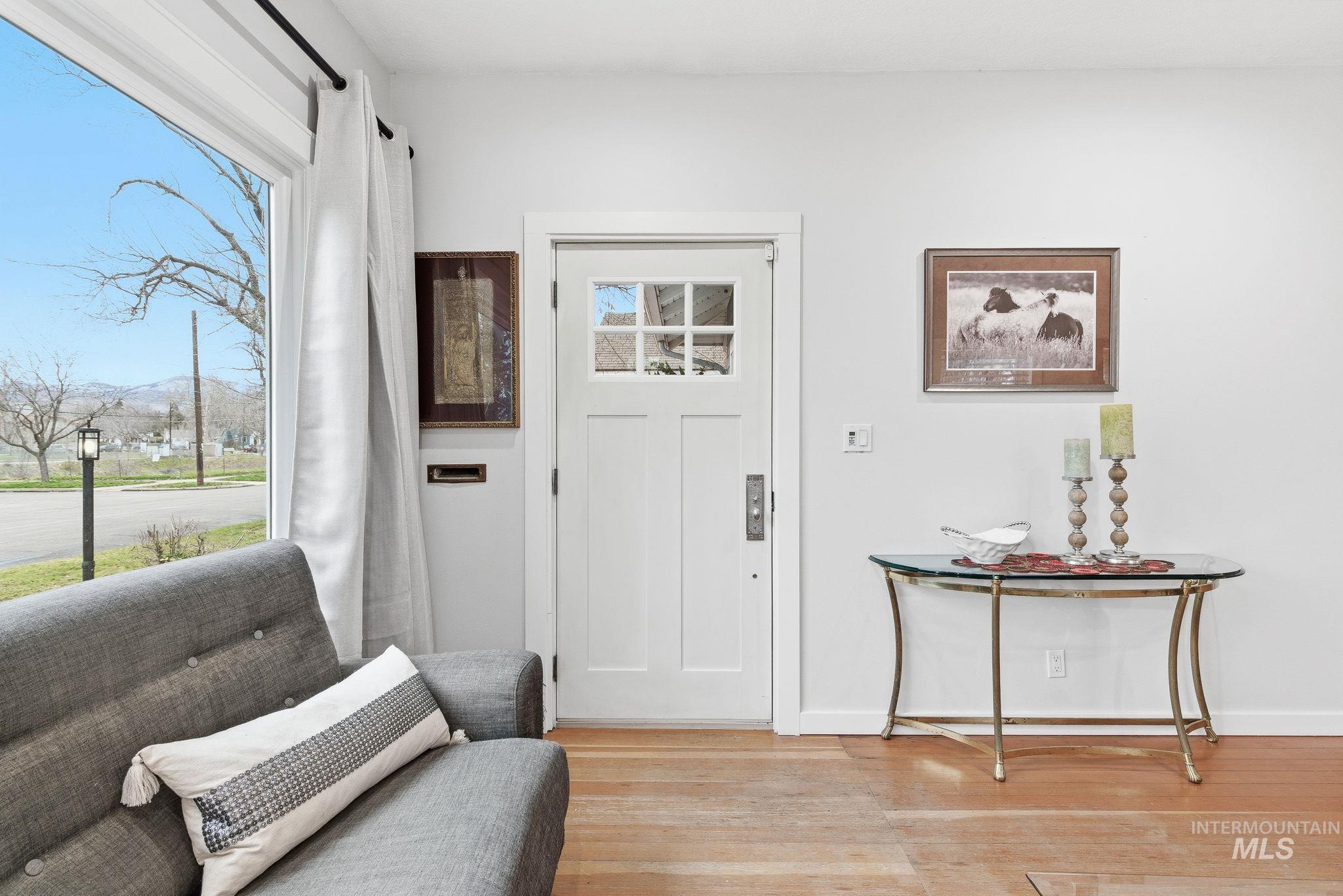 Entryway featuring baseboards and wood finished floors