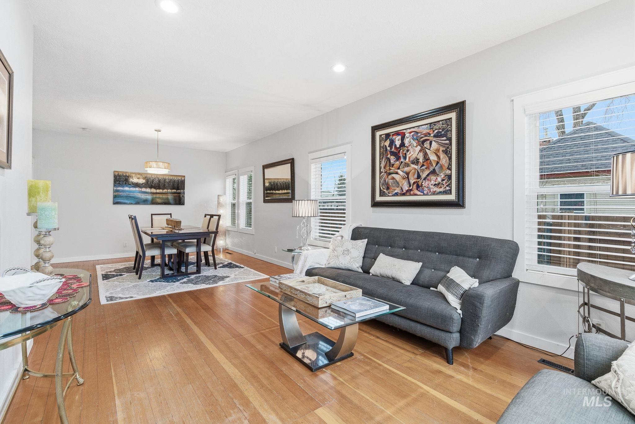 Living room with light wood-style floors and recessed lighting