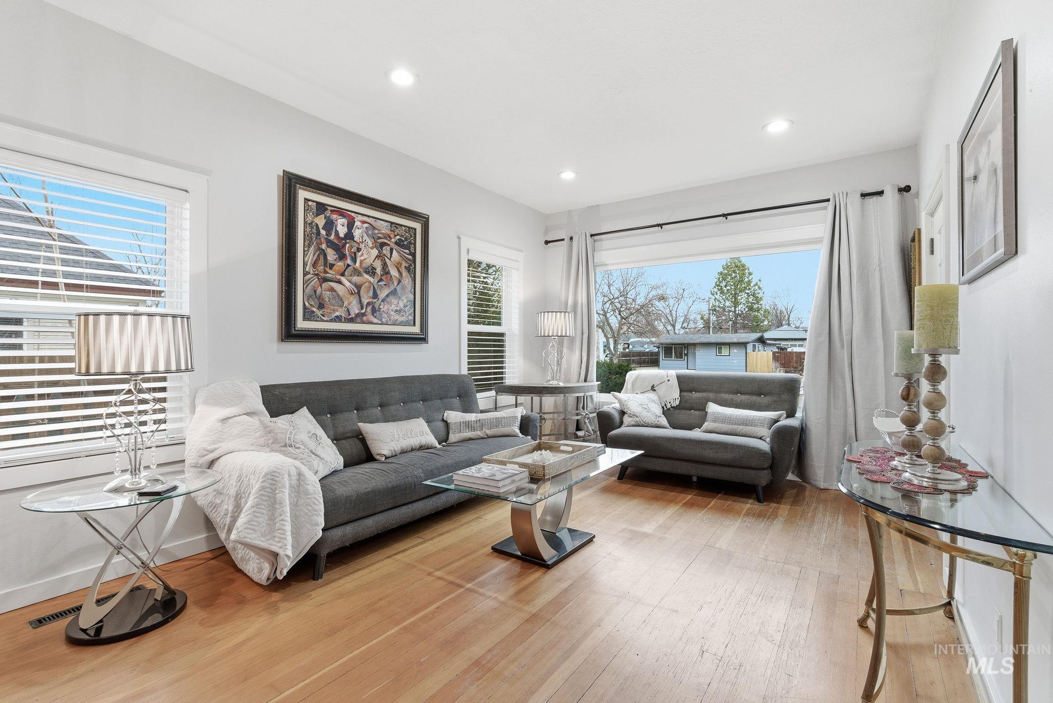 Living area featuring light wood-style floors and recessed lighting