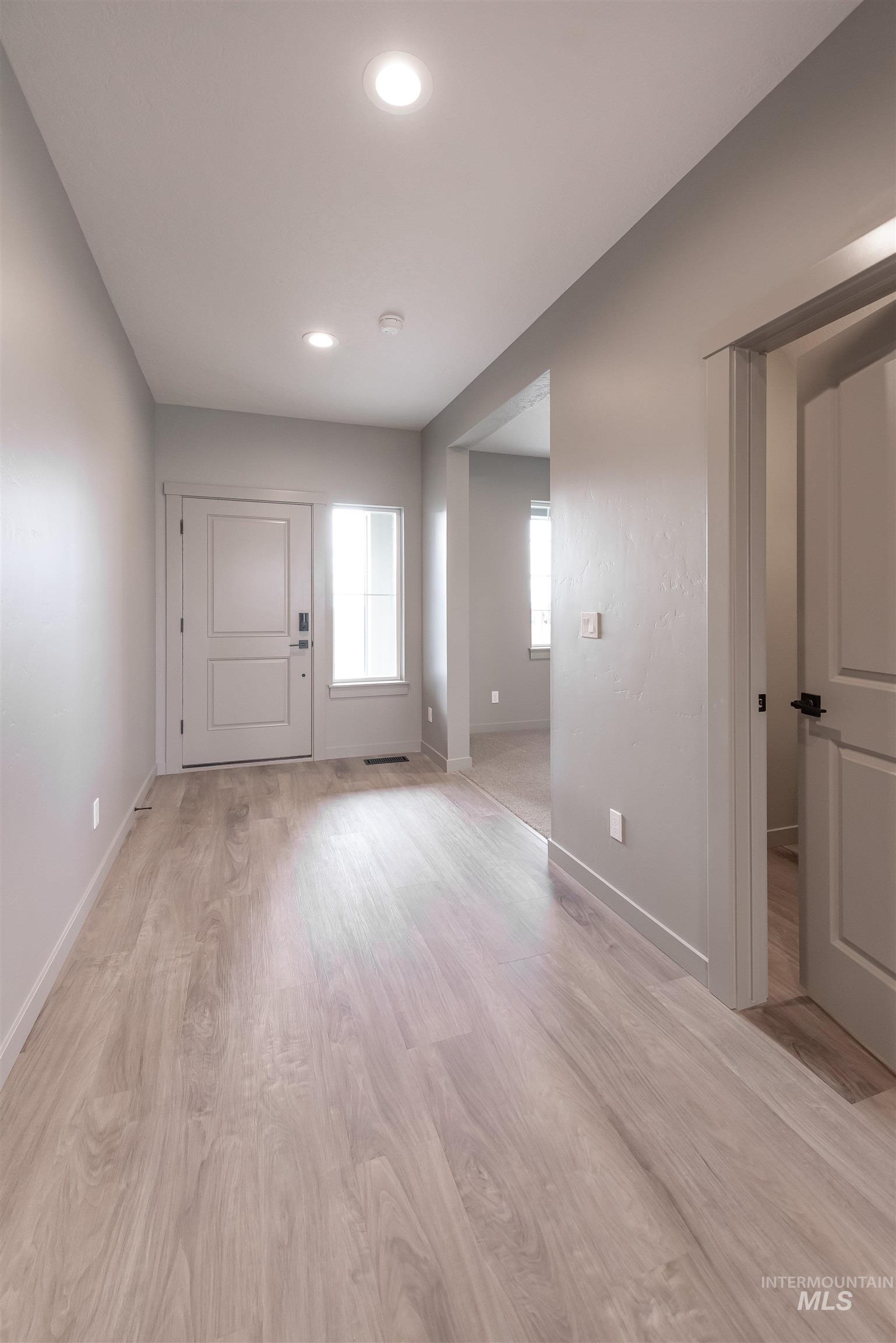 Entrance foyer featuring light wood-style floors and recessed lighting