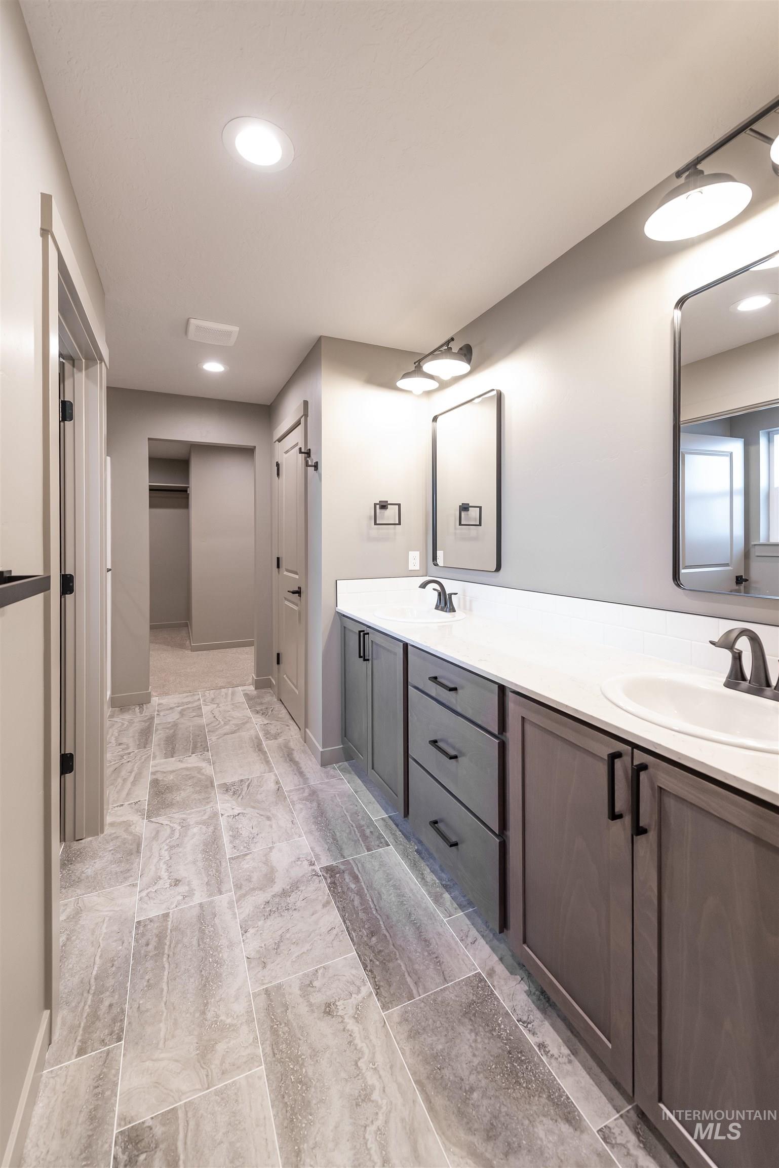 Bathroom featuring double vanity and recessed lighting